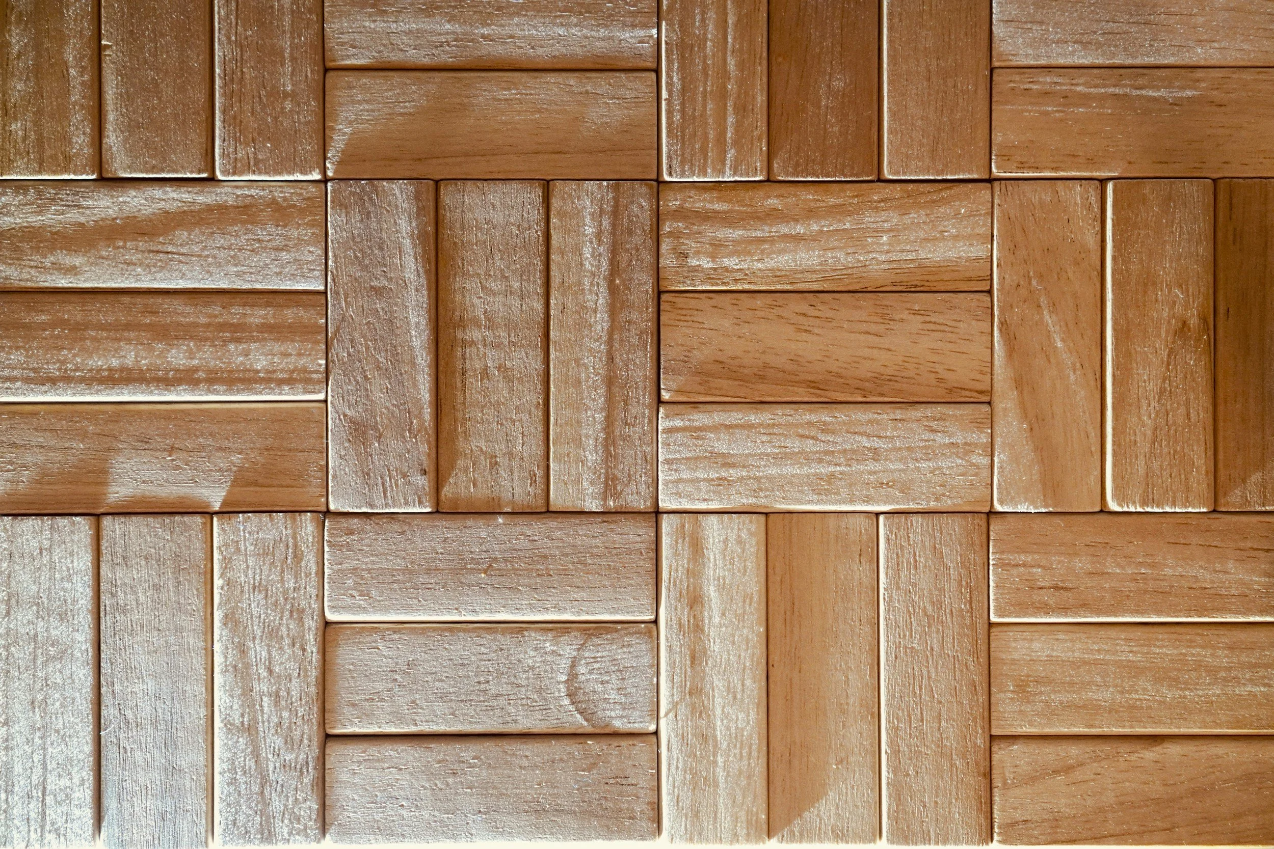 Parque dance floor made of rectangular wooden blocks arranged in a staggered pattern.