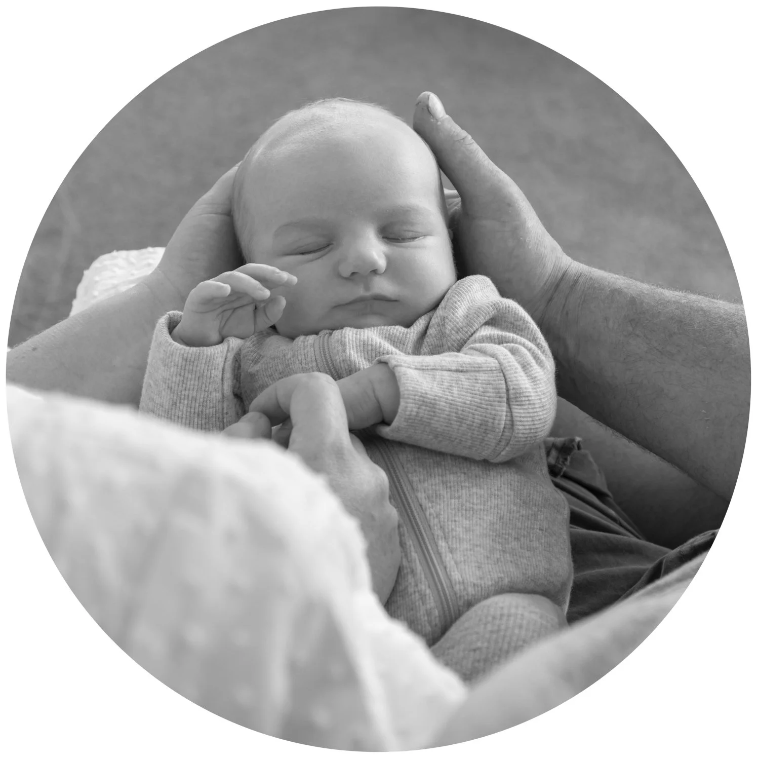 Parents hold newborn baby boy in their hands at in-home family session with Elyse Childs Photography.