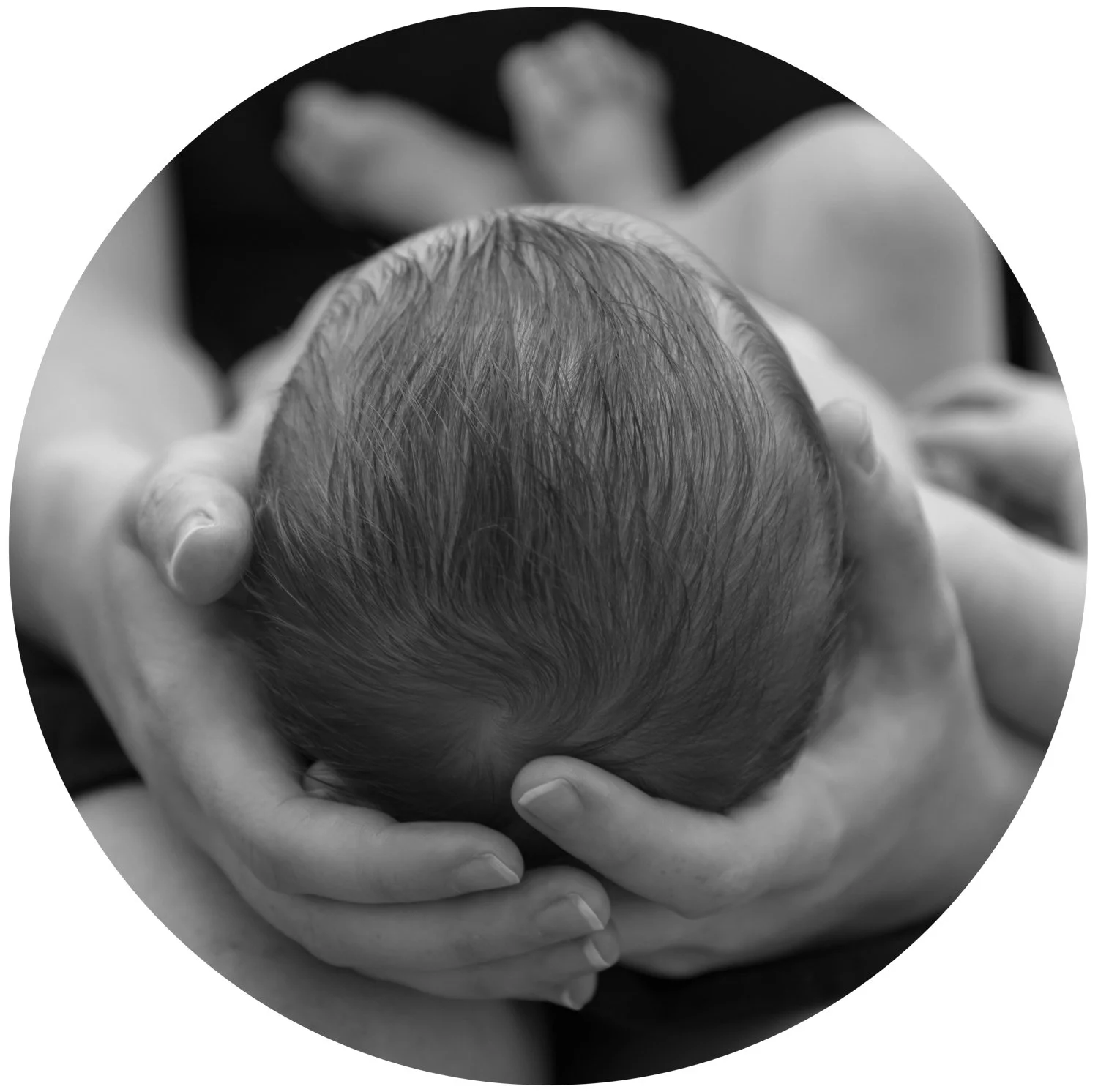 Mother cradles newborn baby