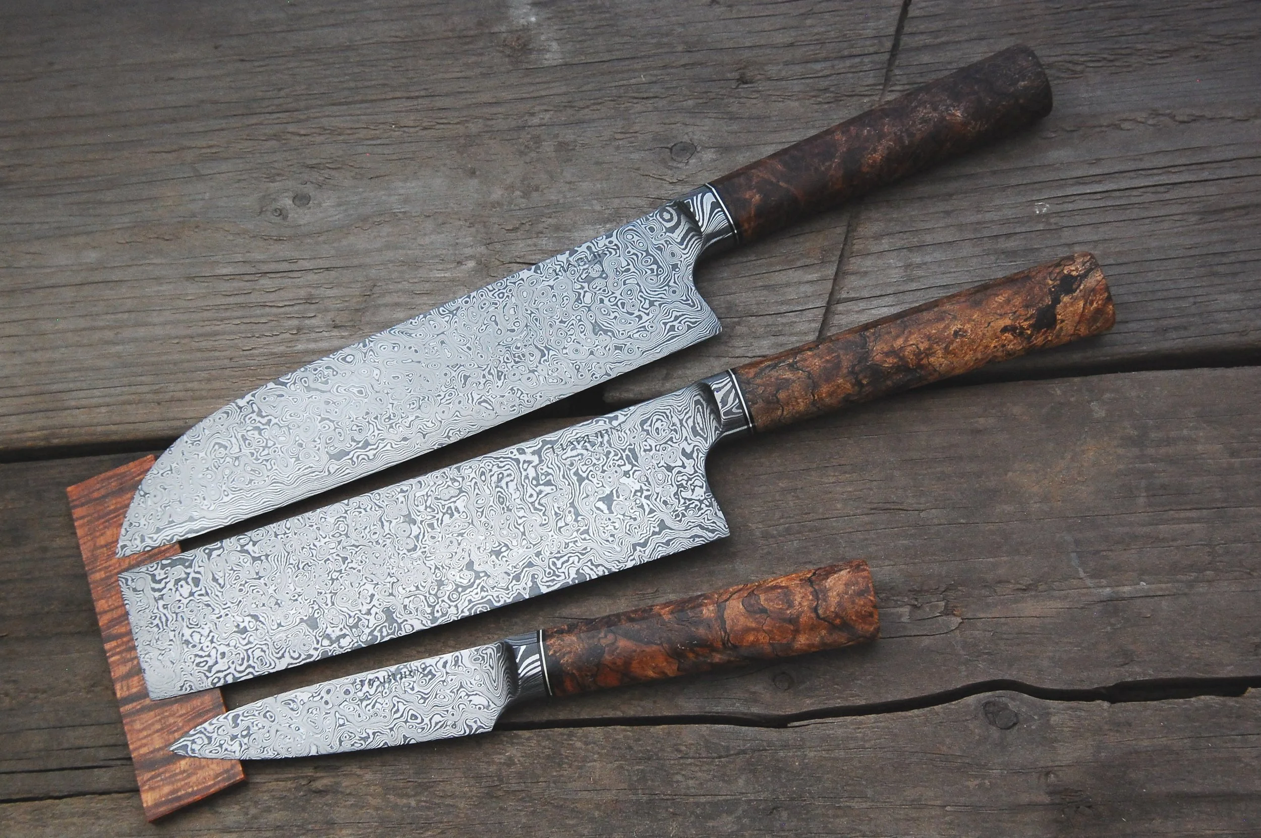 Custom Raindrop Damascus Integral Santoku, Nakiri, and Parer. 