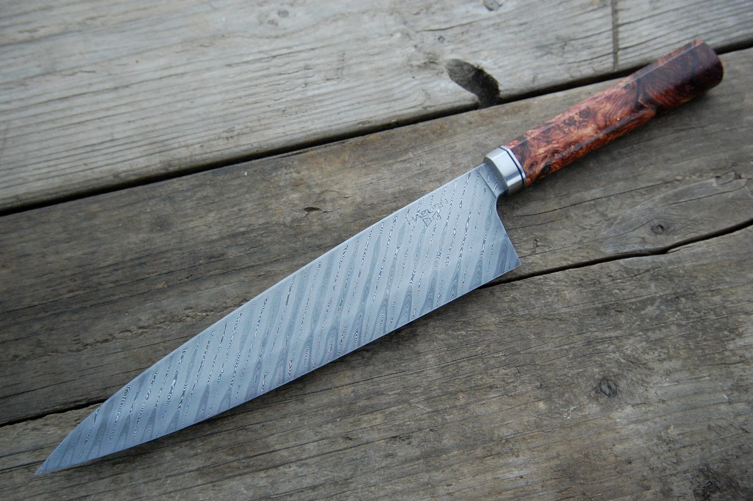 Oblique Damascus with a stainless bolster and rosewood burl
