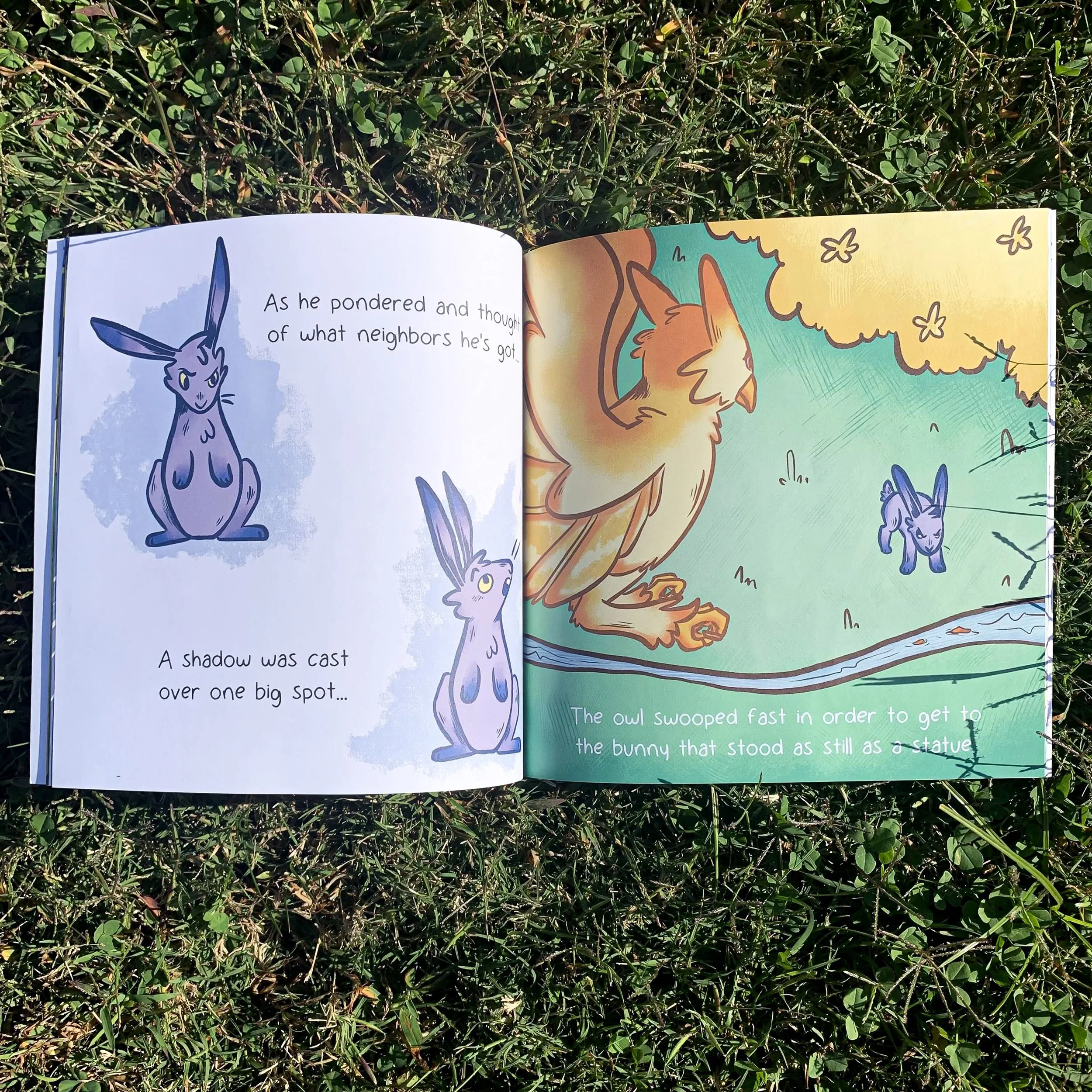 A children's illustrated book open to two pages. The left page shows drawings of a rabbit with large ears, looking somewhat skeptical. The right page shows a large owl swooping down. The background is colorful with green and yellow. The text on the left reads: "As he pondered and thought of what neighbors he's got. A shadow was cast over one big spot..." The text on the right reads: "The owl swooped fast in order to get to the bunny that stood as still as a statue."