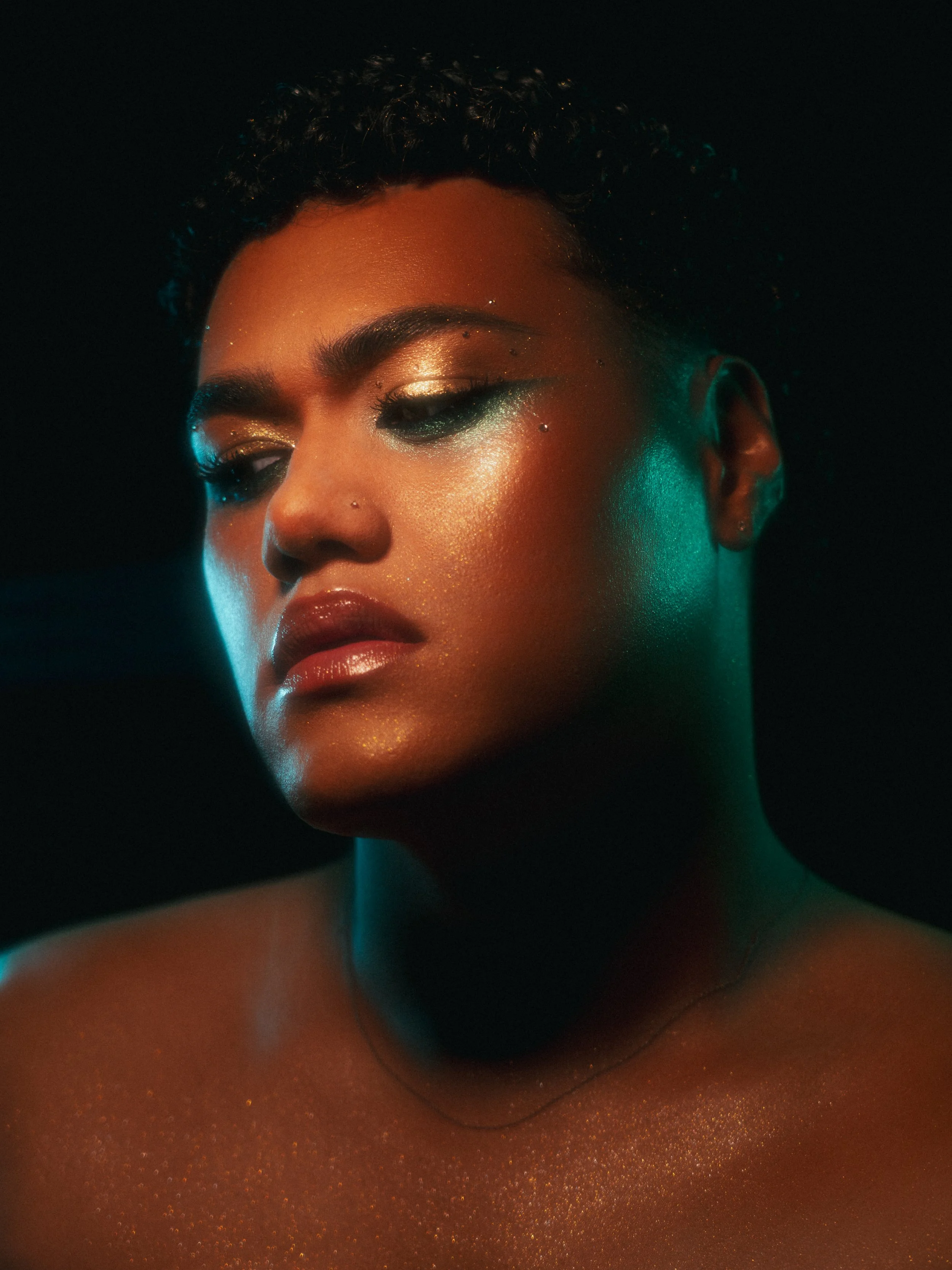 Kylee De Thier in a gold and teal glittery makeup look inspired by Beyonce's All Night and Kehlani's Folded. Editorial, high end, fashion and professional.