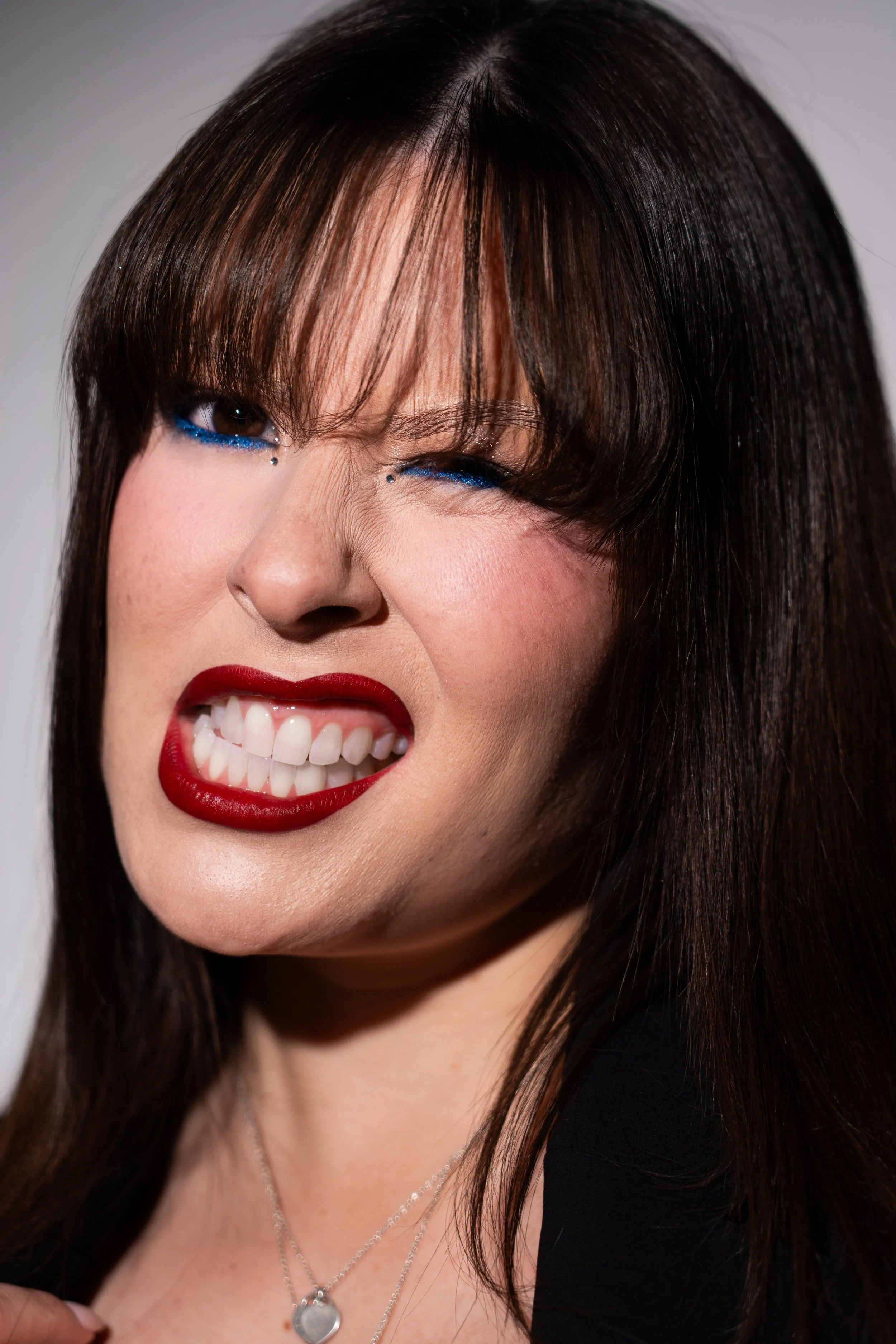Bold blue liner and deep red lip editorial makeup shoot on Alluka Sakura inspired by 'IT Girl' by JADE. Makeup artistry, photography, cinematography, post-production and creative direction by Māori New Zealand (Aotearoa) content creator and influence