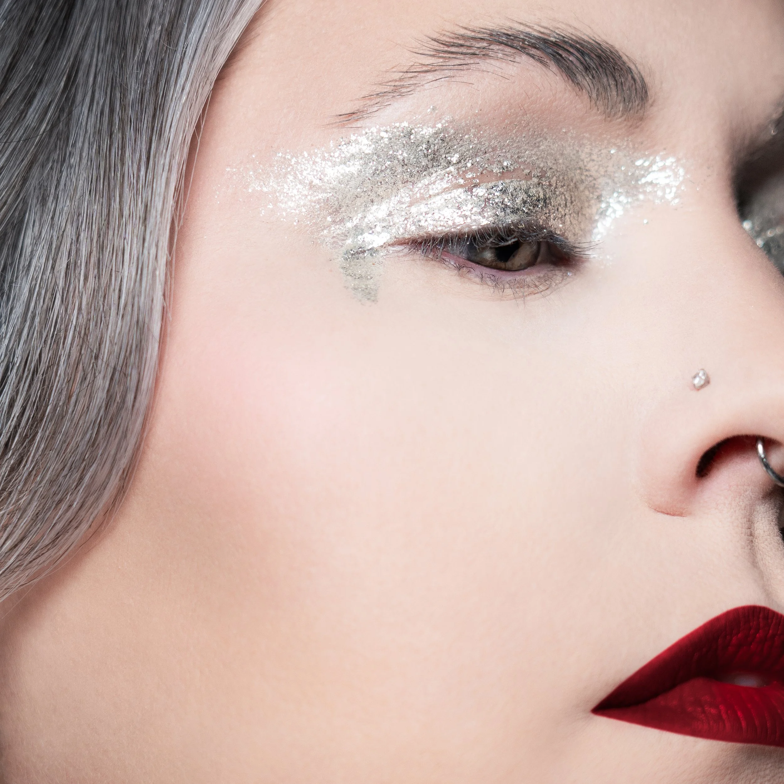 Flawless makeup and photography by Kylee De Thier on Charlotte Cake for her 'Silver Sessions' podcast cover, with a gritty silver eye, bold red lip and plastic skin.