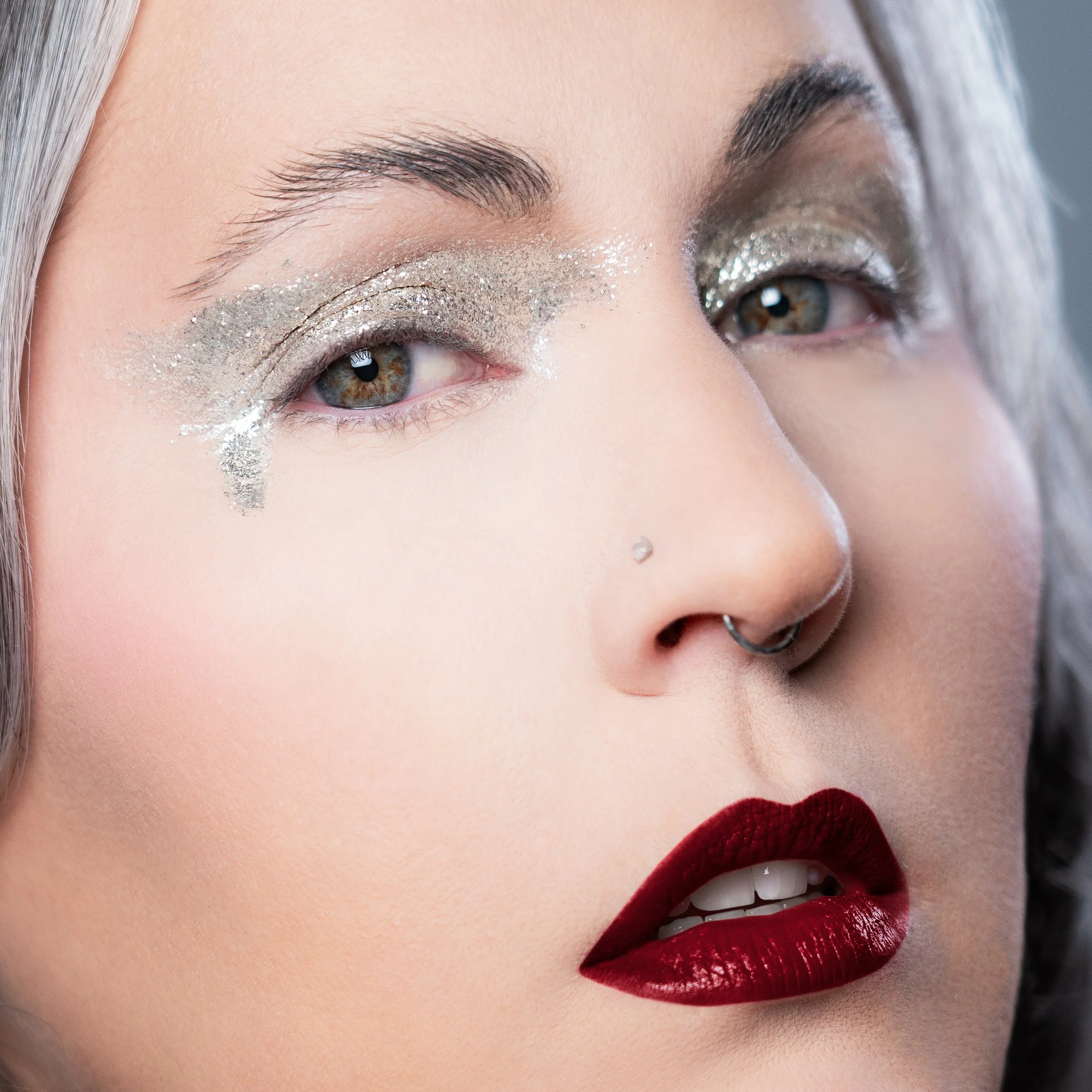 Flawless makeup and photography by Kylee De Thier on Charlotte Cake for her 'Silver Sessions' podcast cover, with a gritty silver eye, bold red lip and plastic skin.