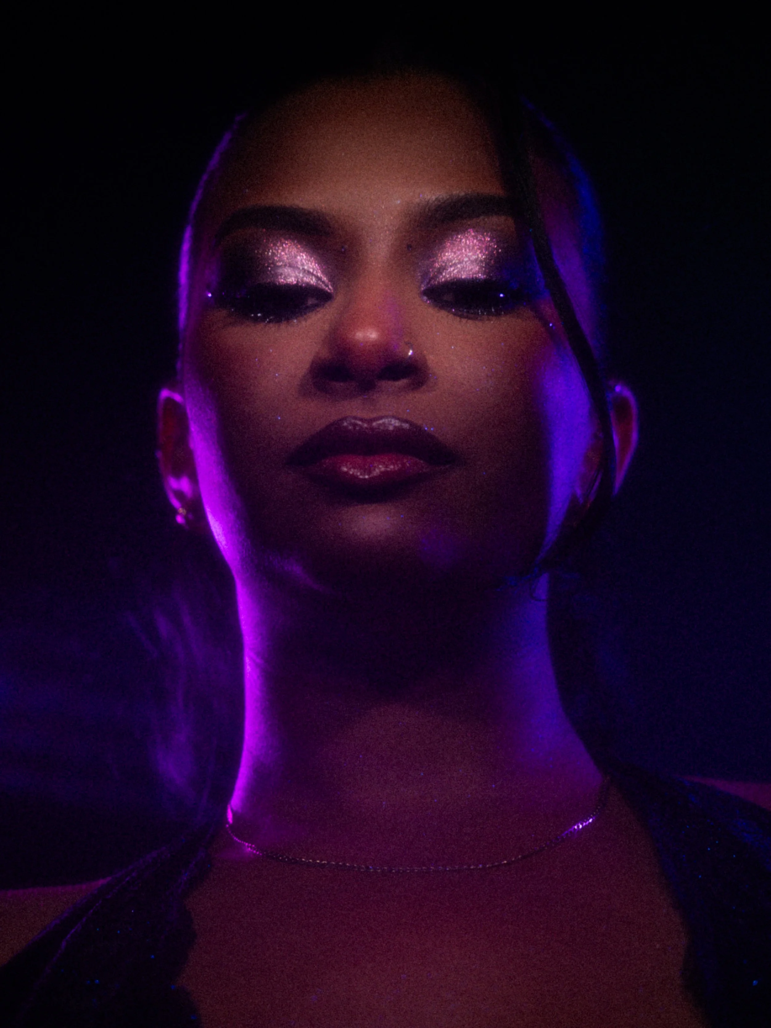 Nikita Chaithoo in a purple glitter makeup look created by makeup artist Kylee De Thier, photography and cinematography by Kylee De Thier