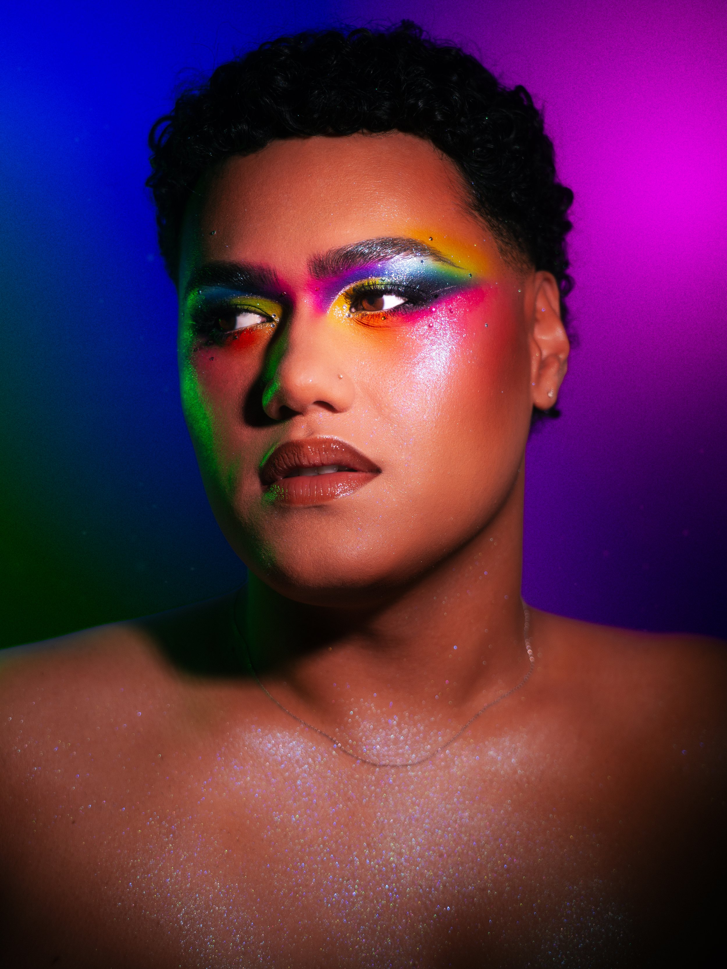 Kylee De Thier wearing a rainbow makeup look inspired by RAYE - Life Boat and Pride Month. 