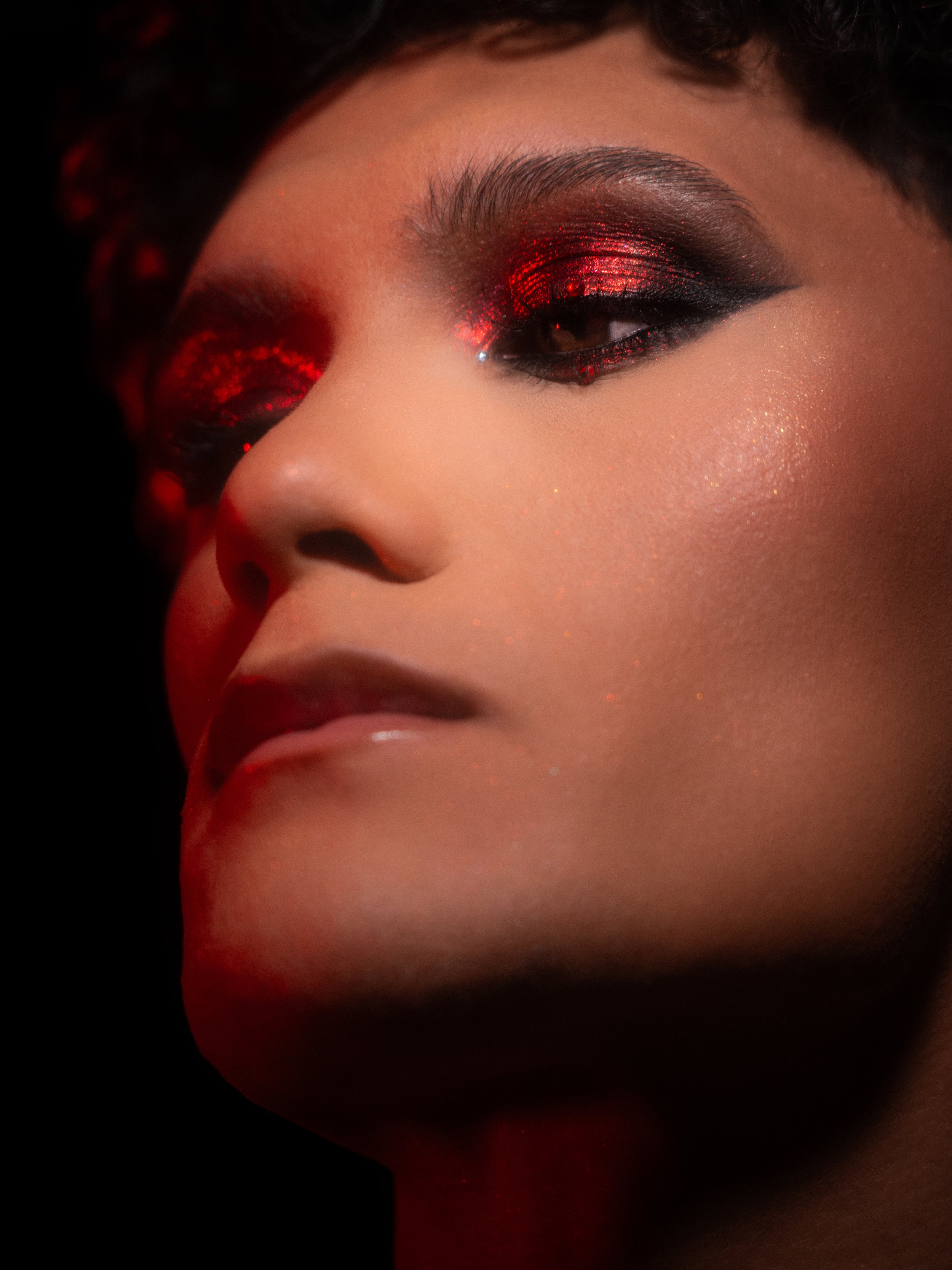 Cherry (Hare Hemopo) in a red makeup look created and photographed by Kylee De Thier