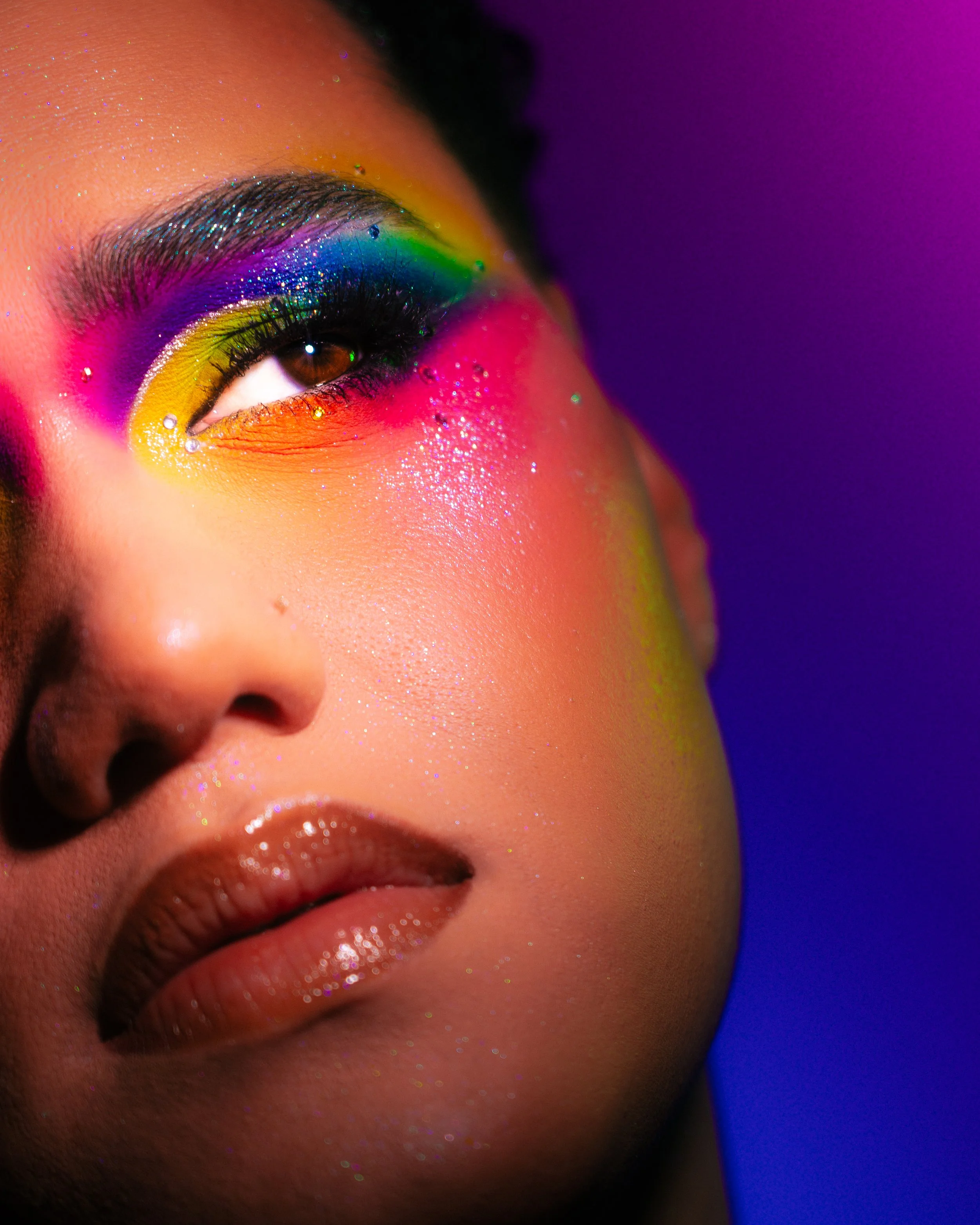 Kylee De Thier wearing a rainbow makeup look inspired by RAYE - Life Boat and Pride Month. 