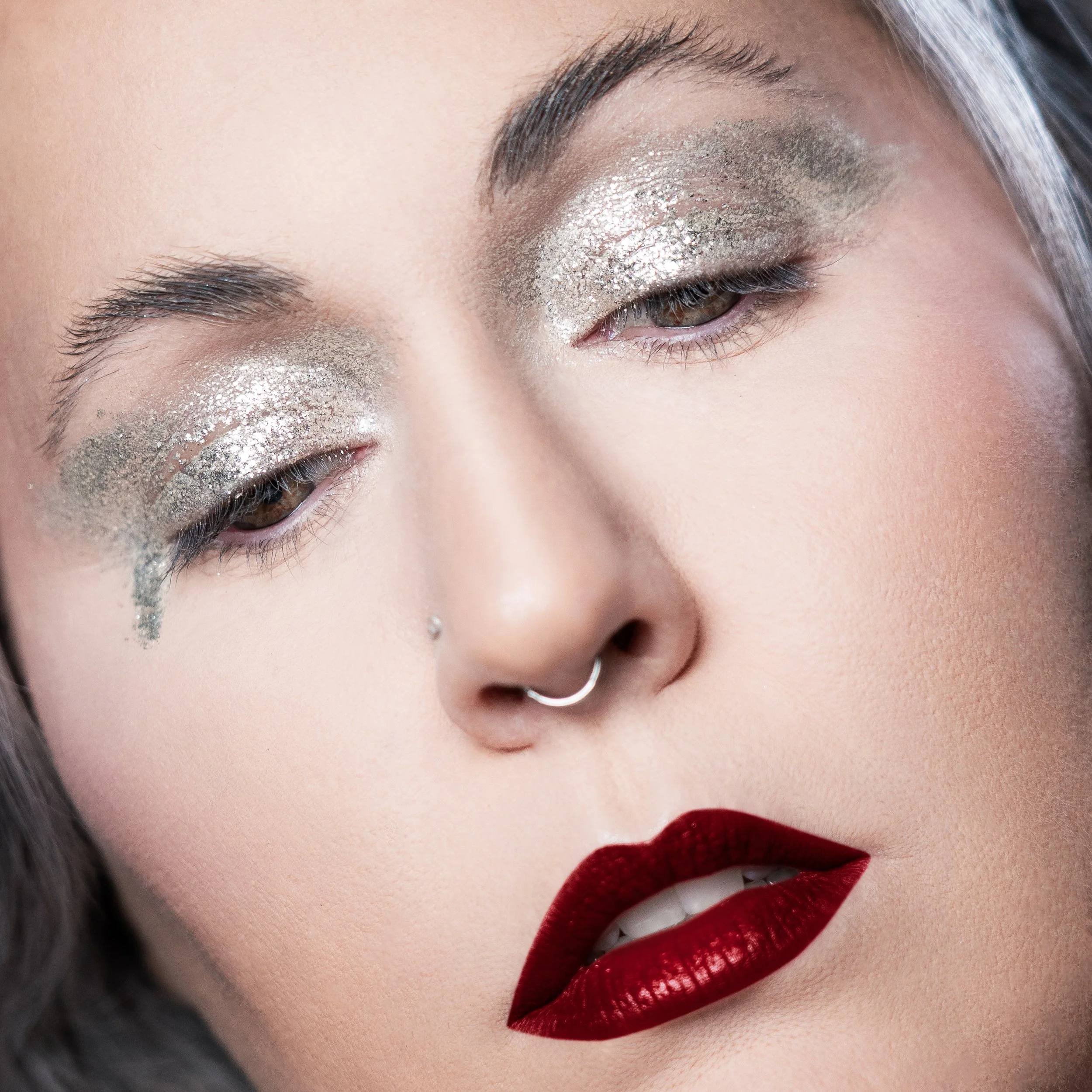 Flawless makeup and photography by Kylee De Thier on Charlotte Cake for her 'Silver Sessions' podcast cover, with a gritty silver eye, bold red lip and plastic skin.