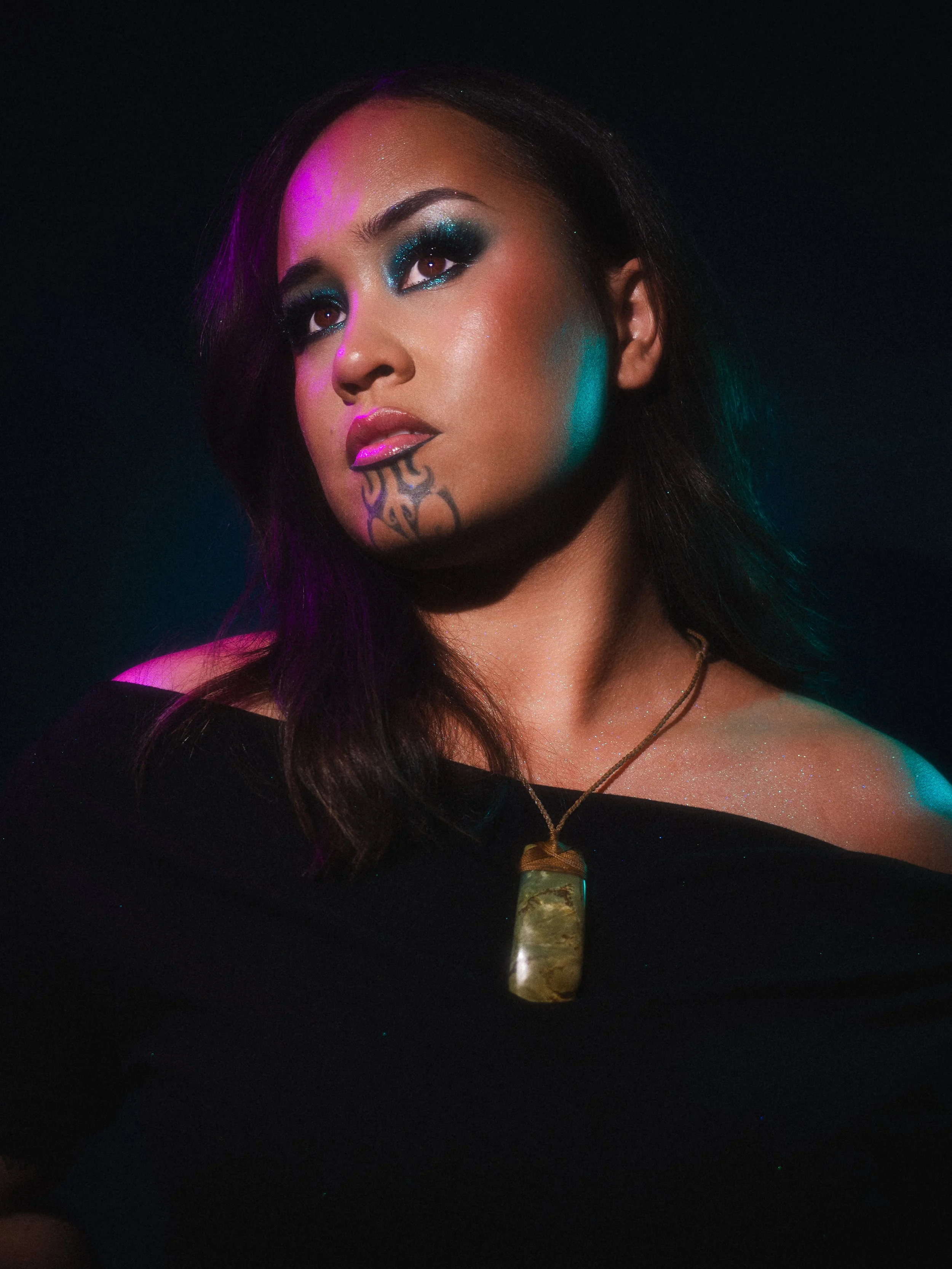 Courtnee Amorangi Māori Content Creator in a editorial makeup look and photoshoot by Kylee De Thier, inspired by Pāua and Matariki, purple and green lights