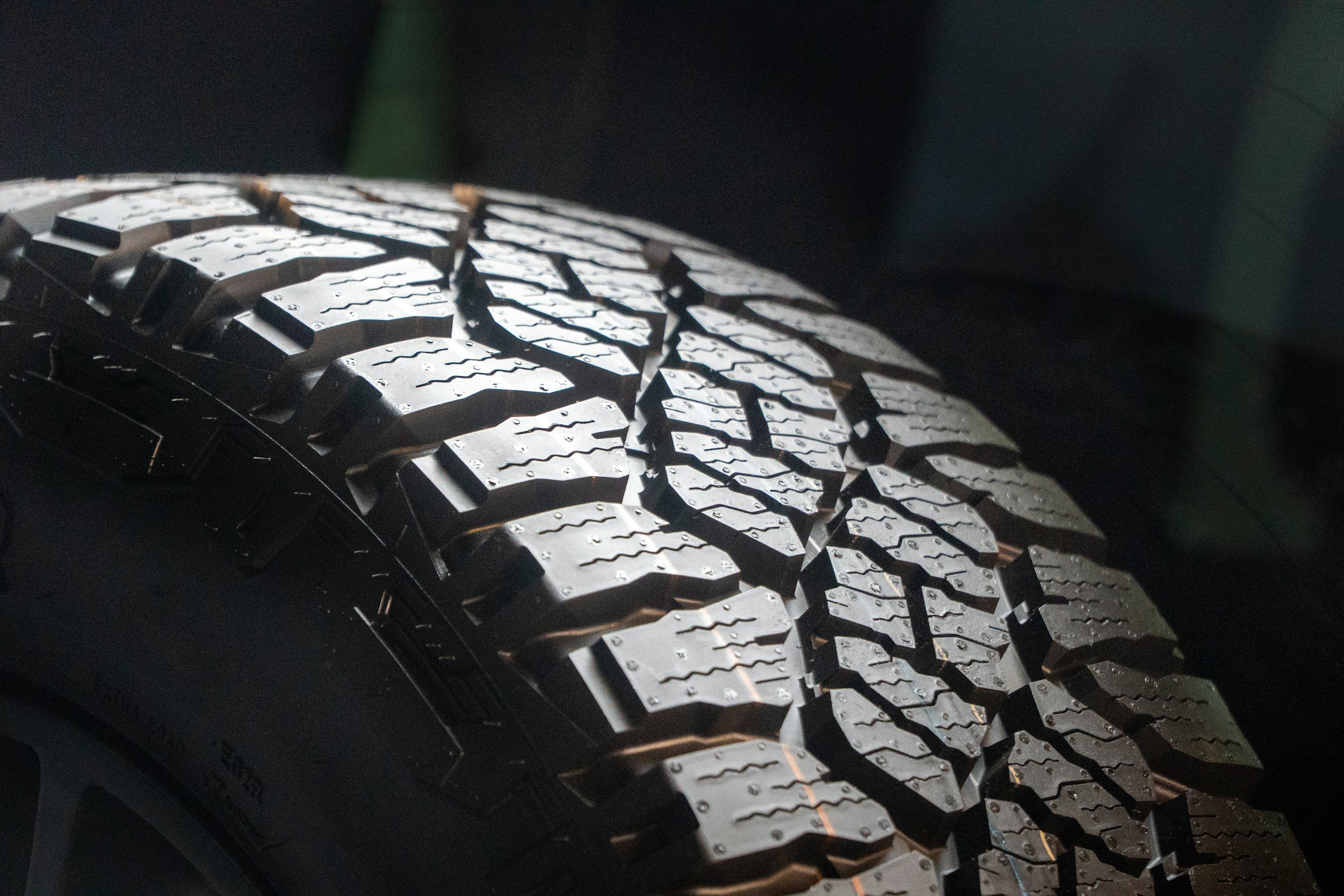 Close-up of a car tire with detailed tread pattern.