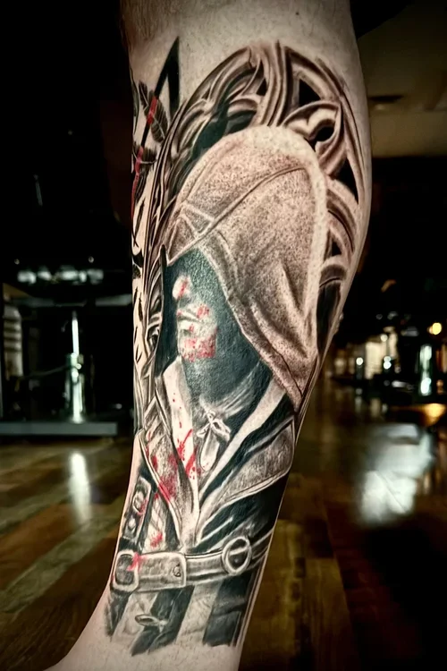 Black and gray tattoo of a cowboy wearing a hat, with a bandana and a belt, on a person's arm.