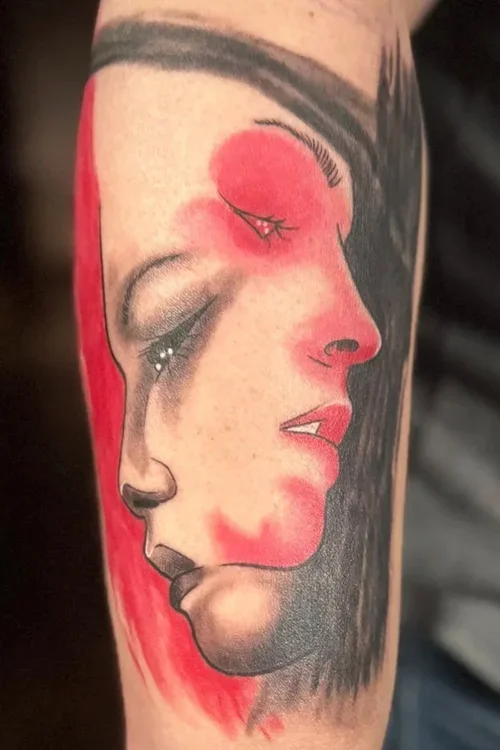 Tattoos of a woman's face in profile with a red background.
