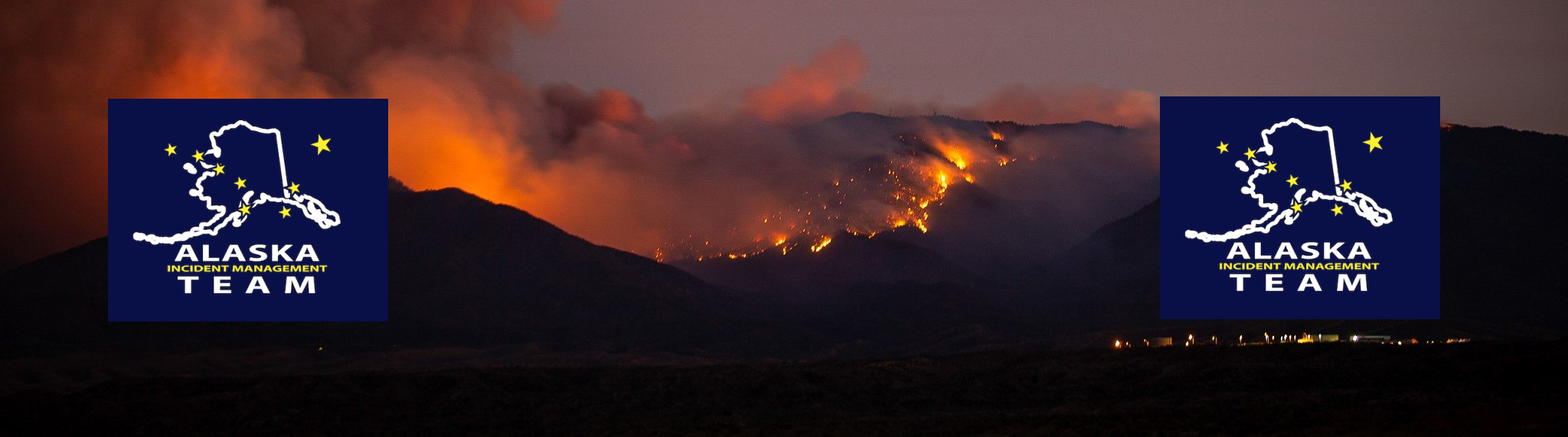 A wildfire burning in the mountains with flames and smoke in the background. Two logos of the Alaska Incident Management Team are visible, one on each side of the image.