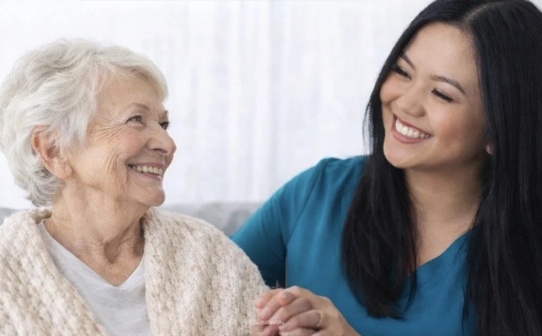 A smiling woman wearing a black shirt with a stethoscope around her neck.