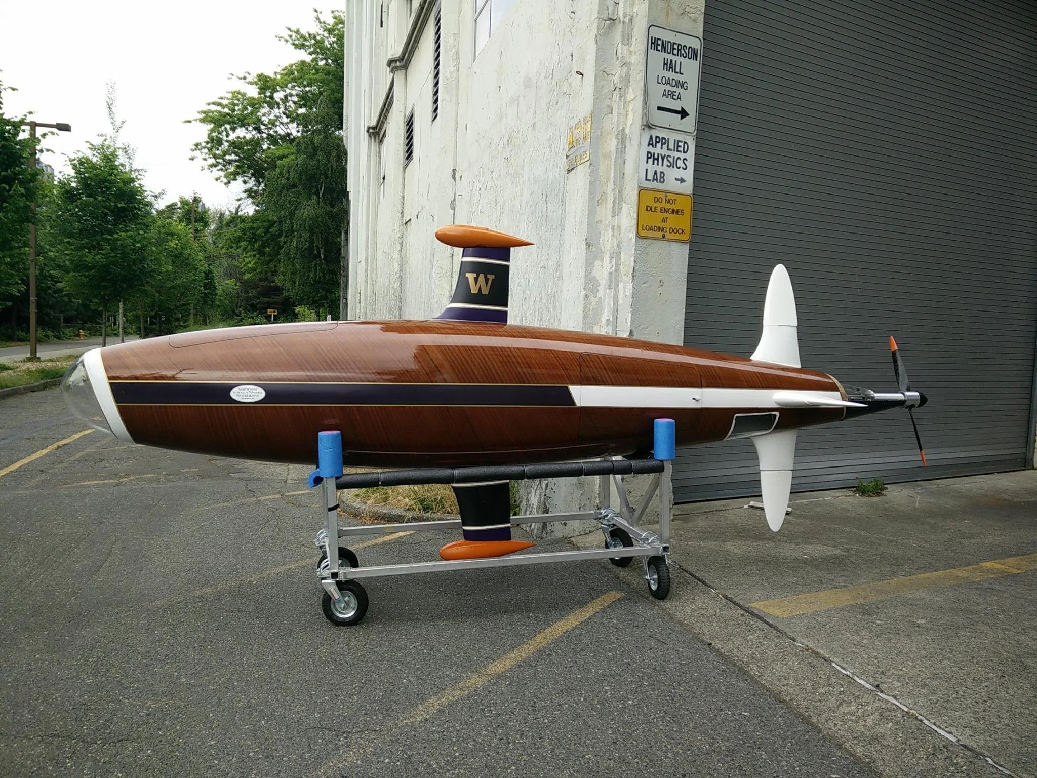 Knotty Dawg, a sleek wooden sub, on it's cart outside of the Applied Physics Lab at UW