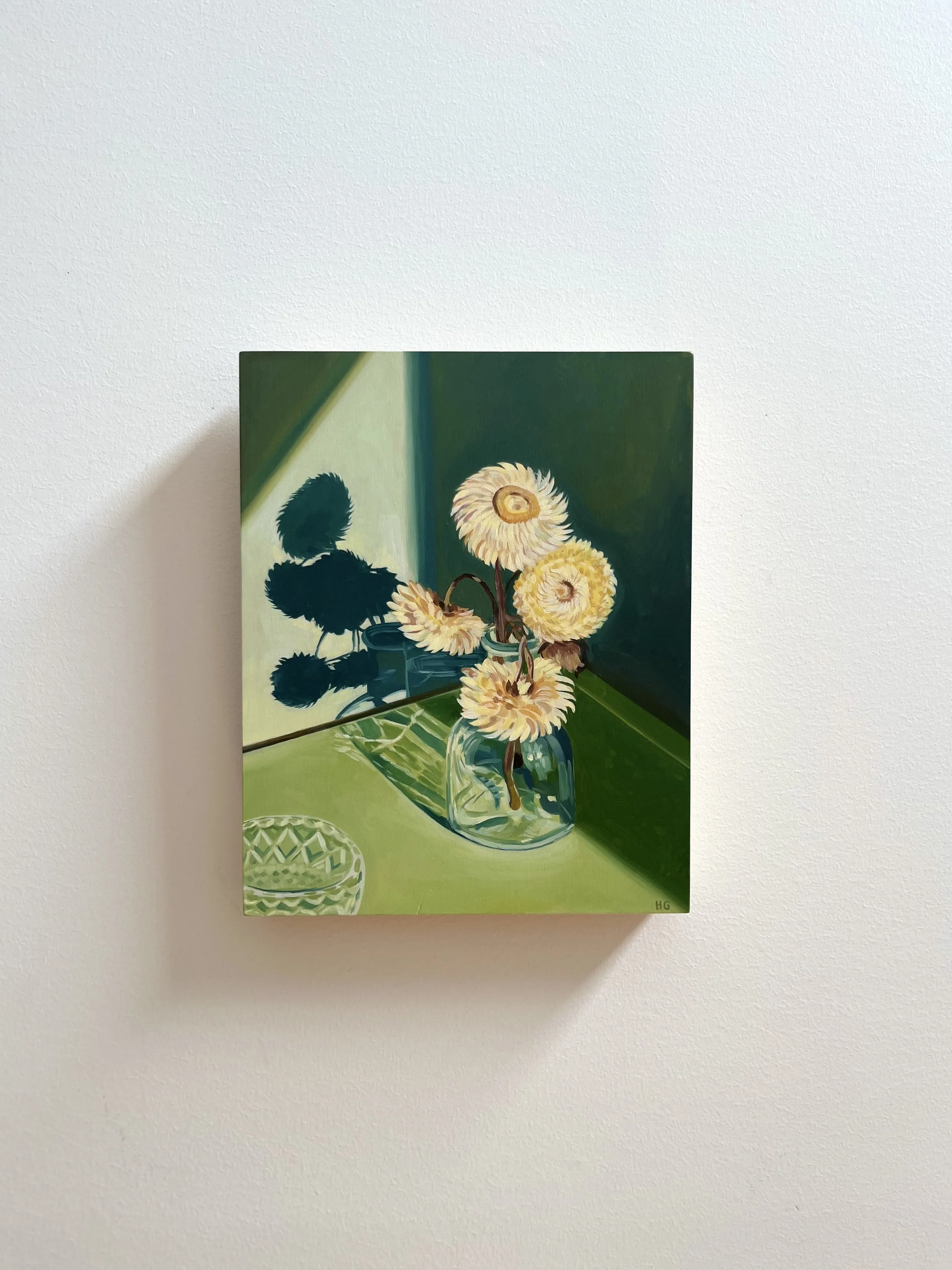 Paper daisies in glass bottle