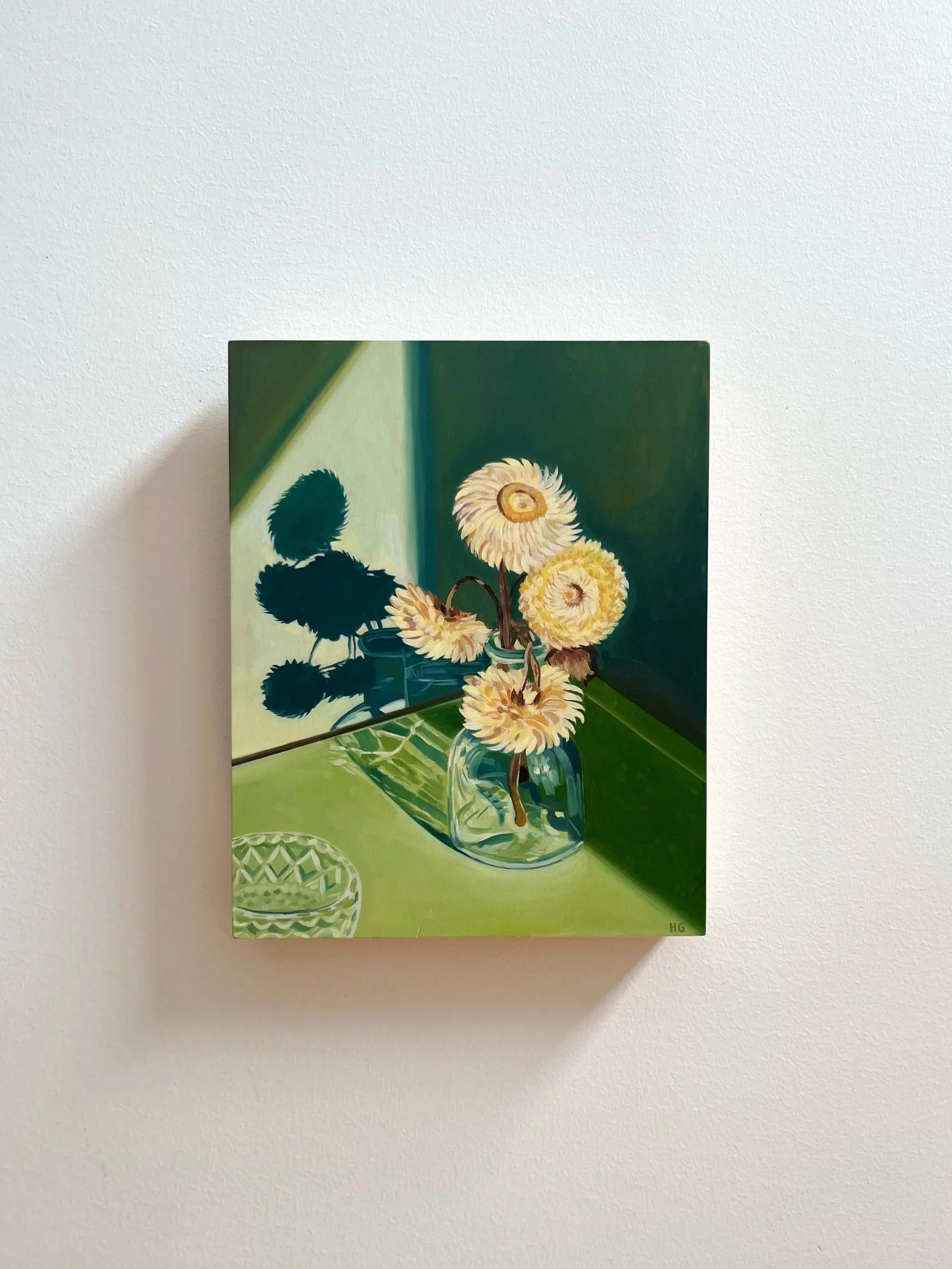 Paper daisies in glass bottle