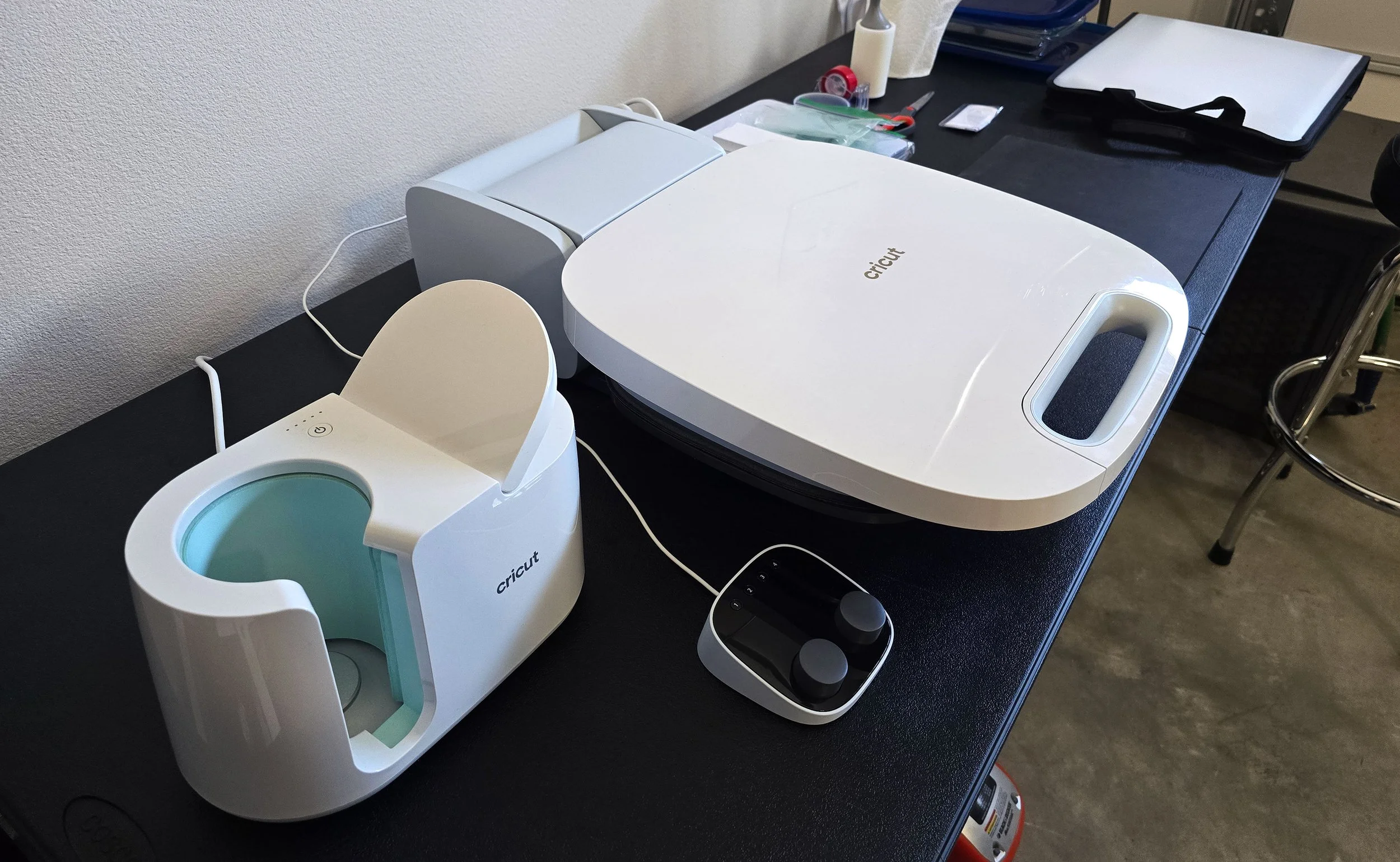 A work table for heat pressing. I use a press to transfer my designs onto earrings, magnets, and mousepads