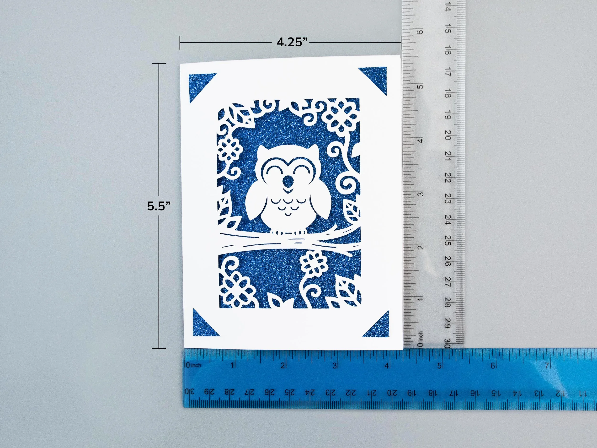A greeting card next to rulers to show scale. The card is 4.25” wide and 5.5” tall