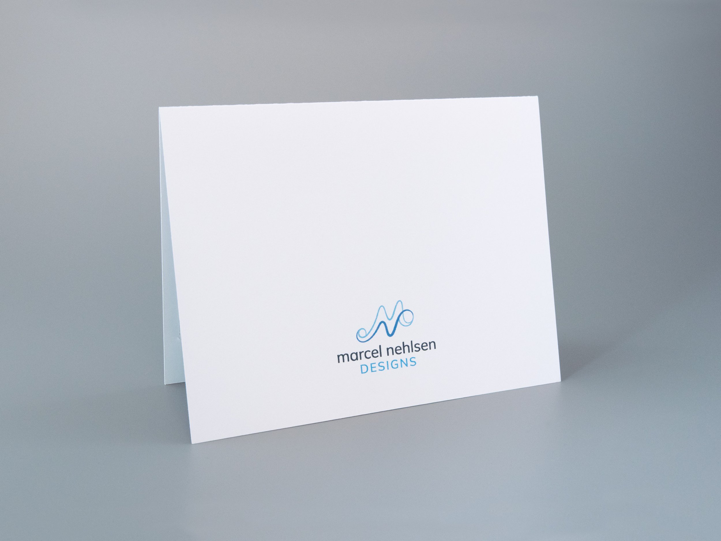 Back side of a motorcycle greeting card. There is a Marcel Nehlsen Designs logo at the bottom