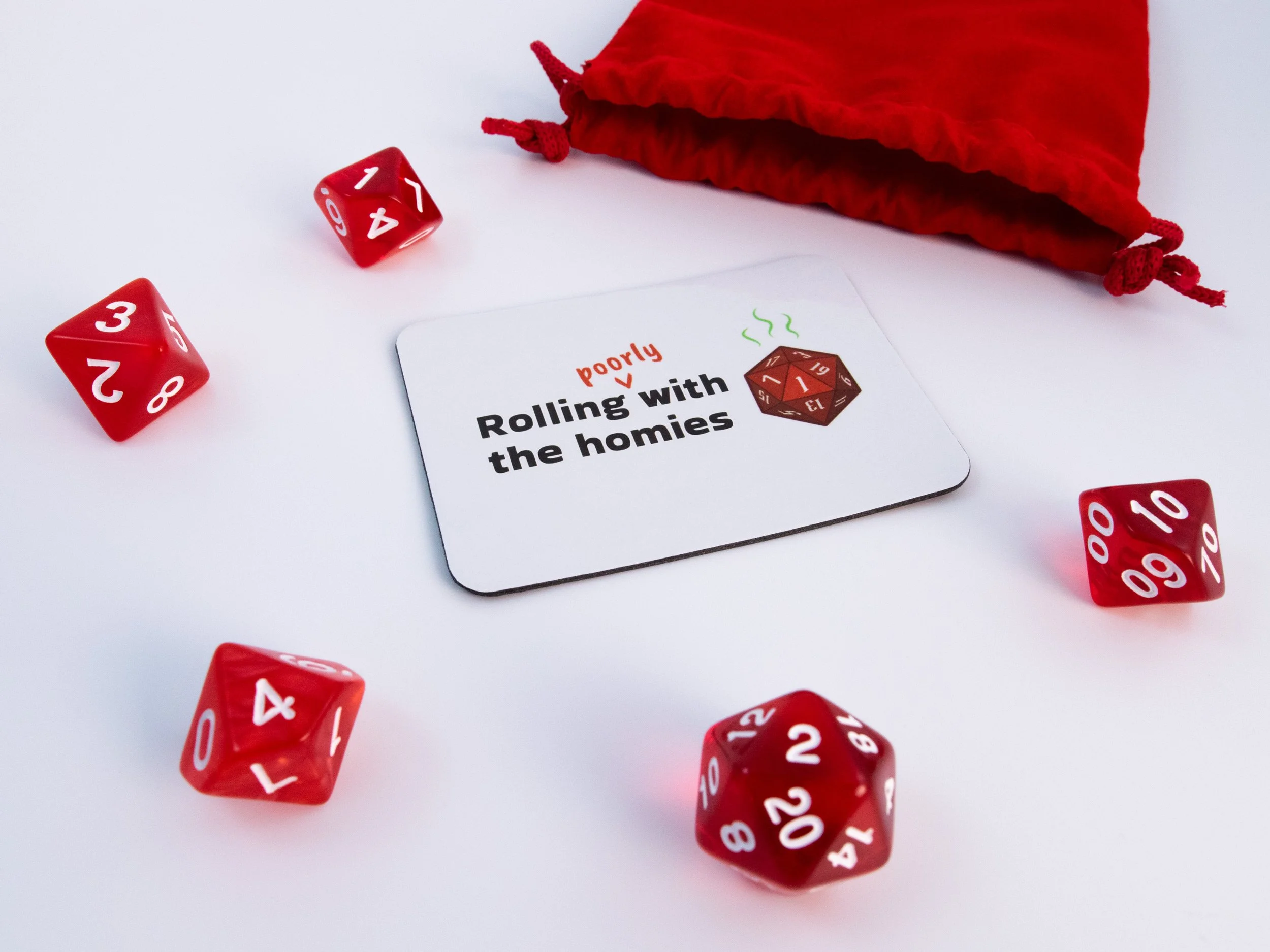 A sublimated magnet with a design that says "Rolling poorly with the homies." The magnet is surrounded by red dice and a dice pouch