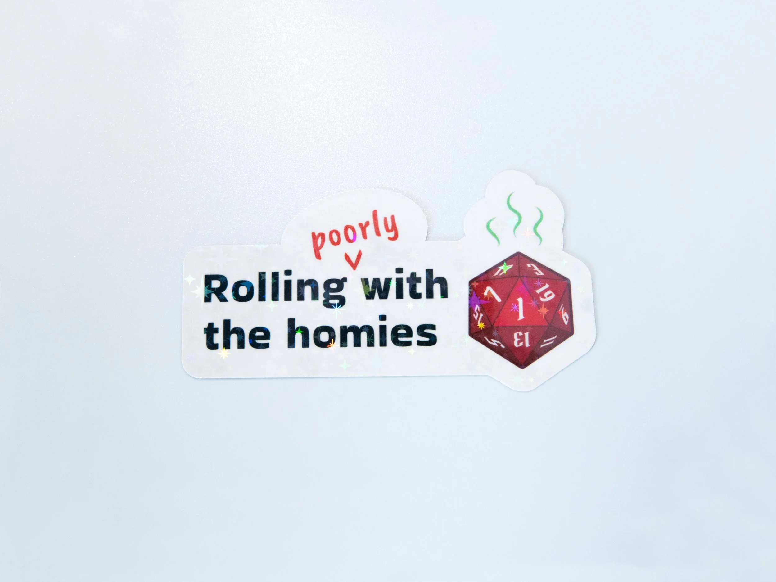 “Rolling poorly with the homies” sticker with a holographic stars finish