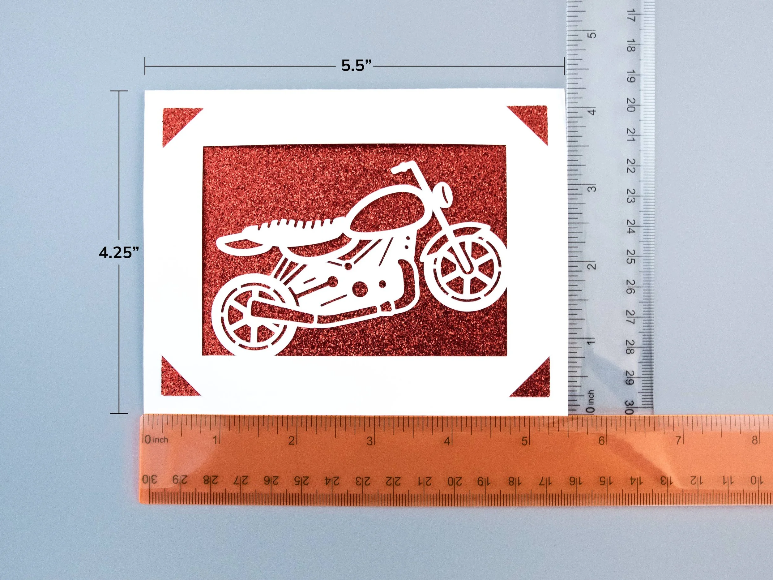 A greeting card next to rulers to show scale. The card is 5.5” wide and 4.25” tall