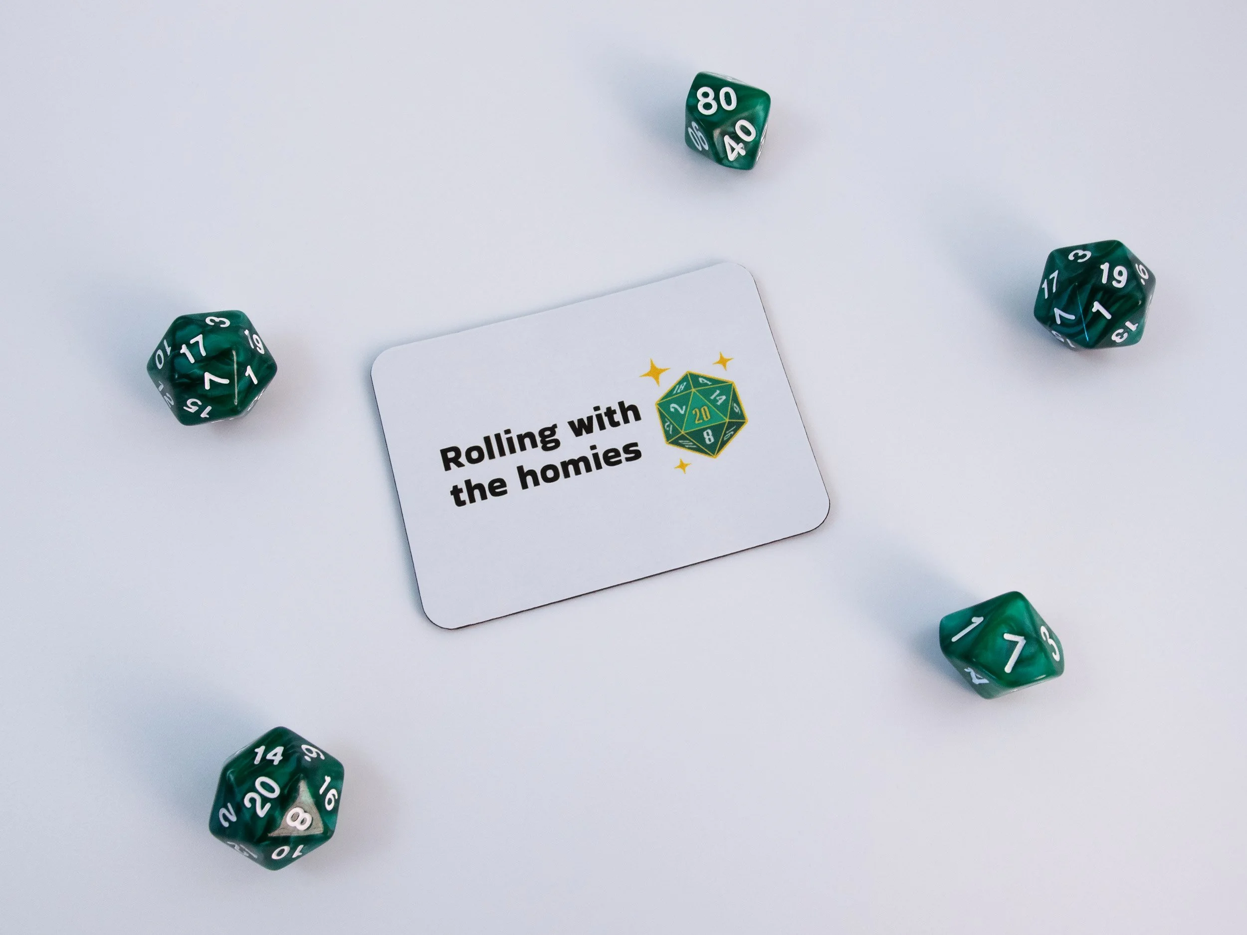 A sublimated magnet with a design that says "Rolling with the homies." The magnet is surrounded by green dice