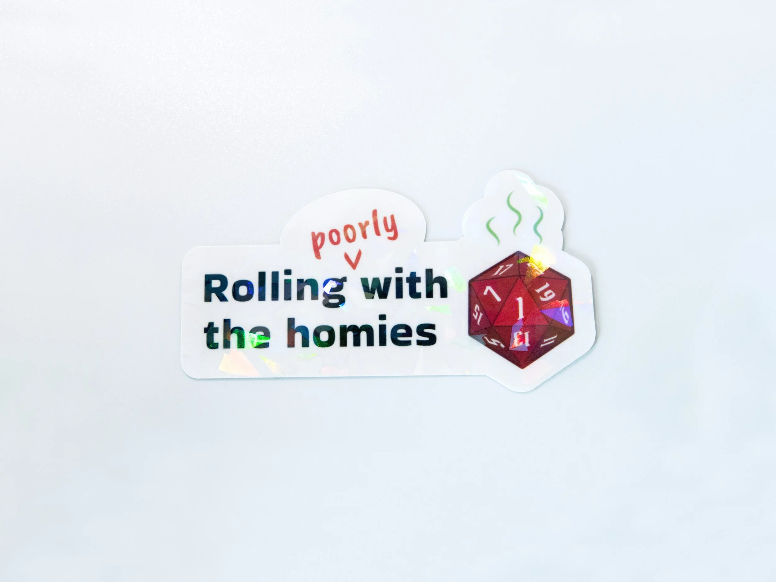 “Rolling poorly with the homies” sticker with a holographic broken glass finish