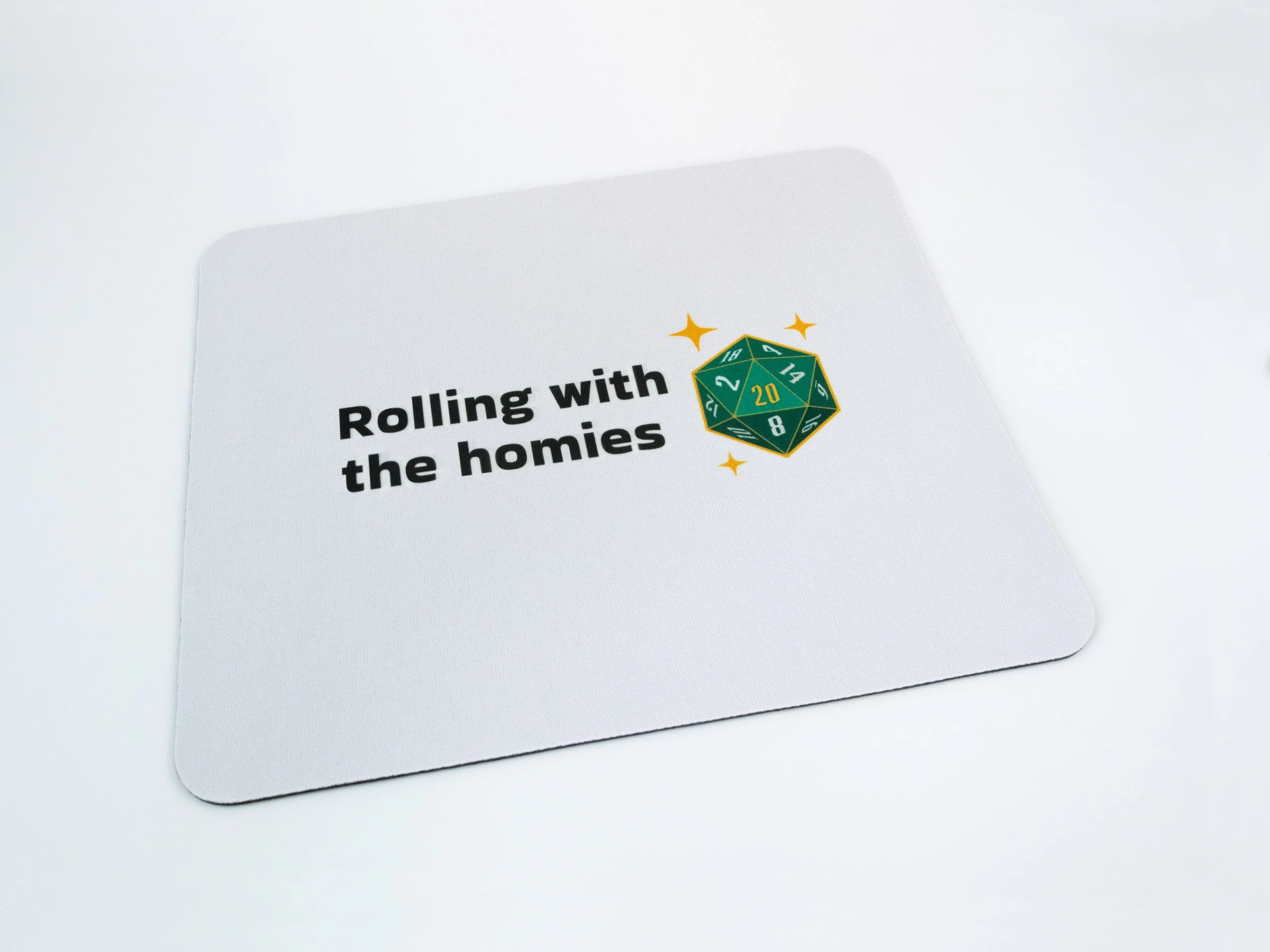 A sublimated mousepad. The design says "Rolling with the homies" and features a green d20 die