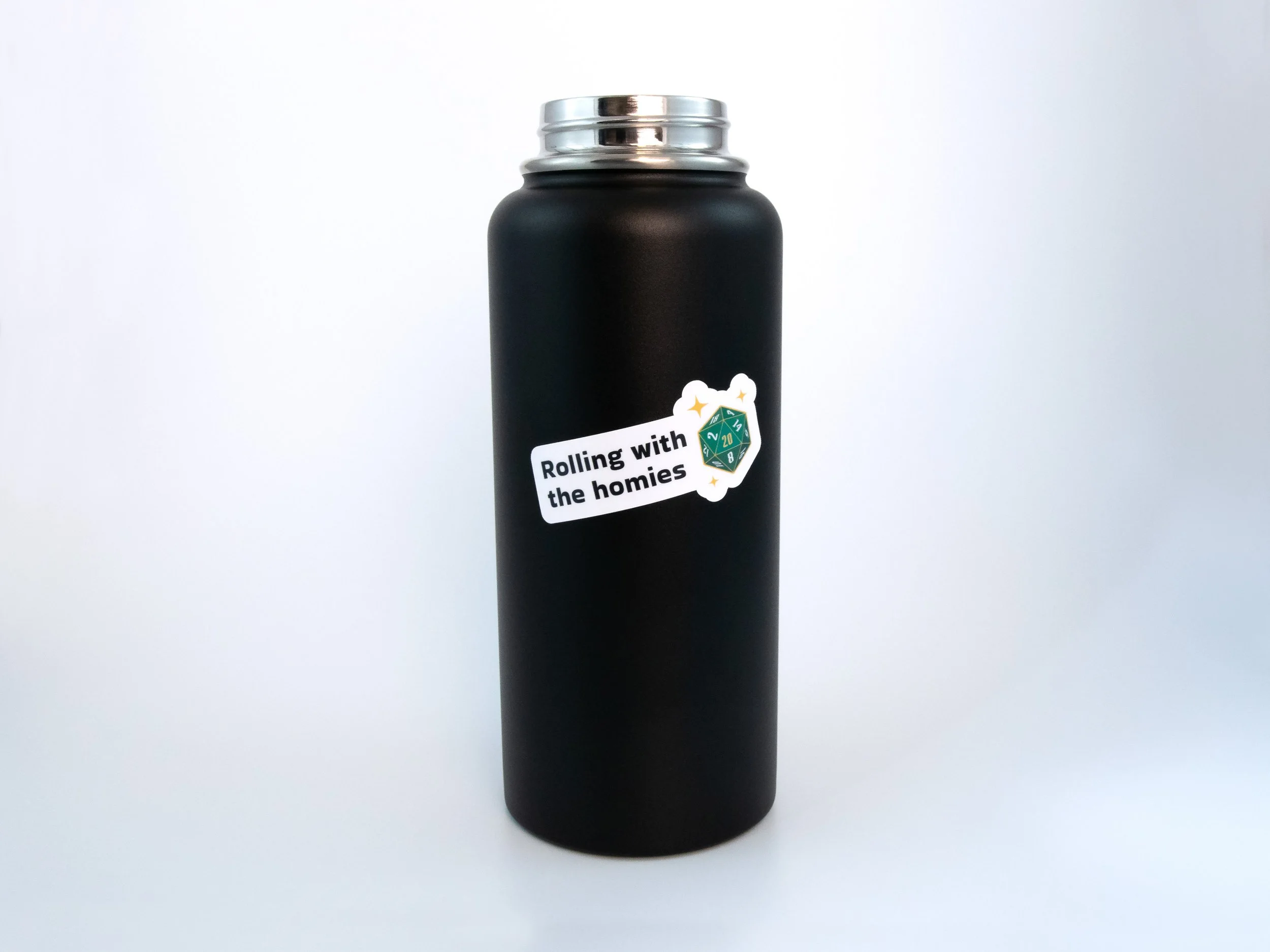A sticker of a green d20 die with text that says “Rolling with the homies”. The sticker is on a black water bottle