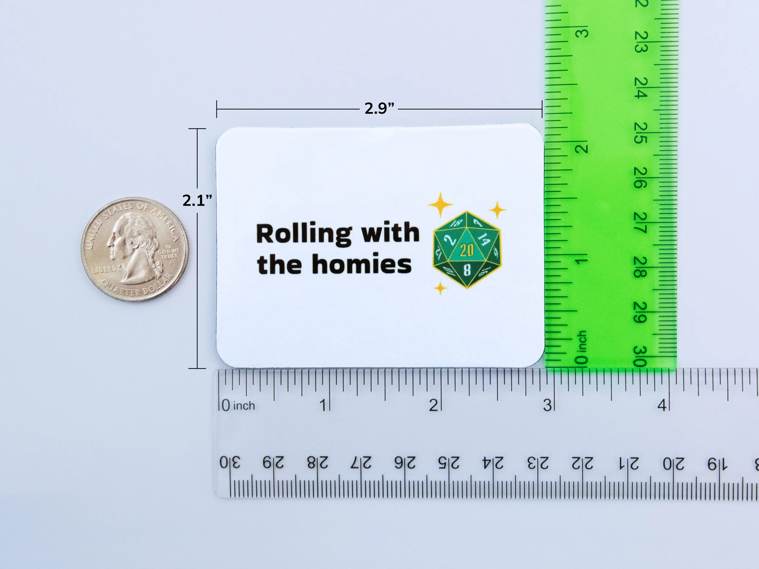 A magnet next to rulers and a quarter to show scale. The magnet is 2.9” wide and 2.1” tall