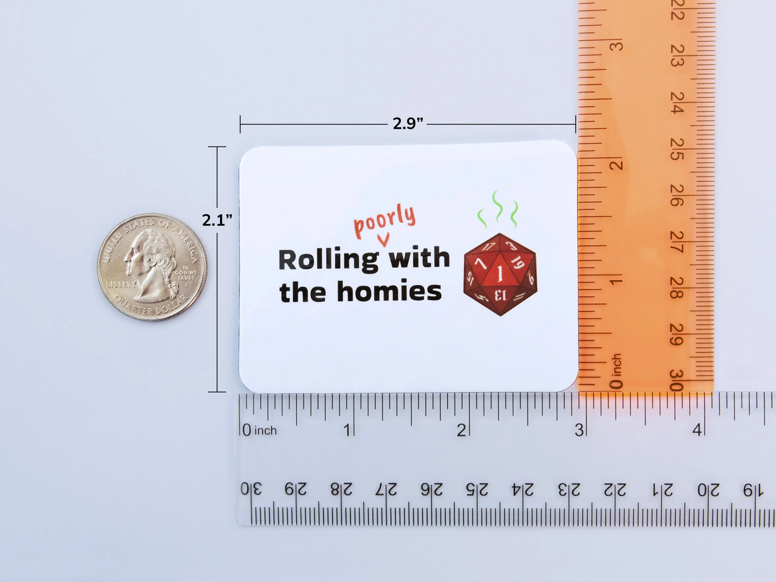 A magnet next to rulers and a quarter to show scale. The magnet is 2.9” wide and 2.1” tall
