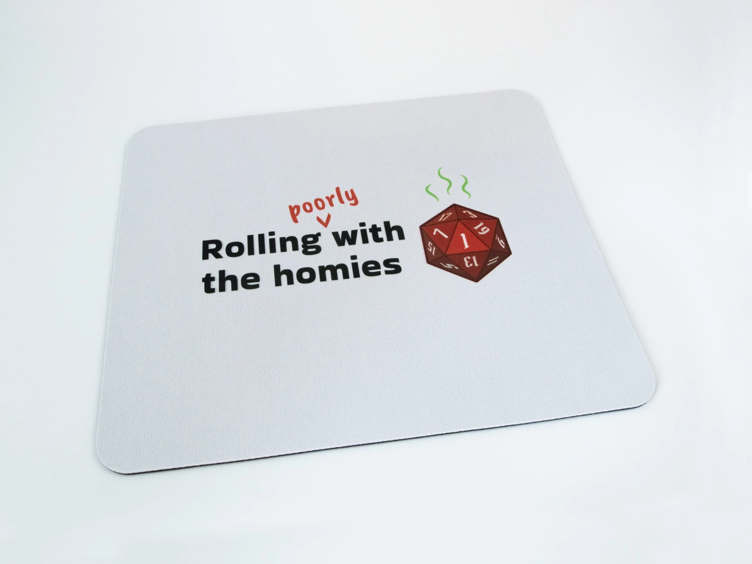 A sublimated mousepad. The design says "Rolling poorly with the homies" and features a red d20 die