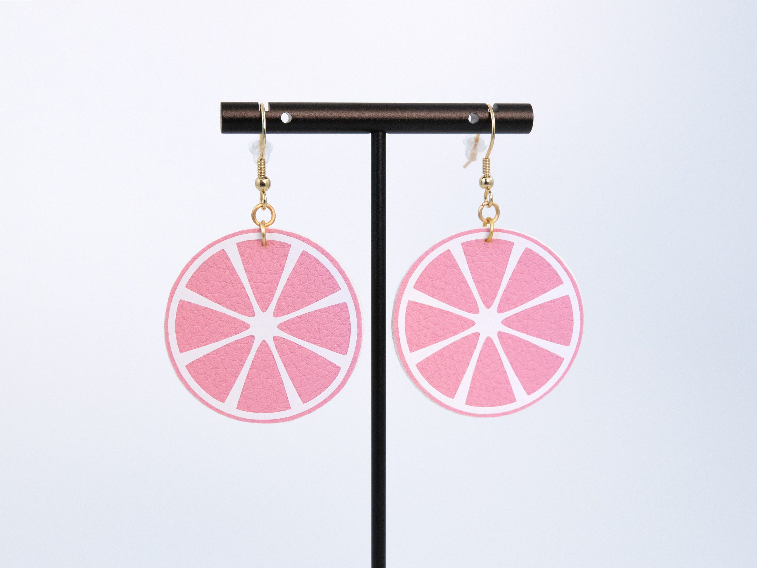 Citrus earrings made from pink faux leather and white vinyl