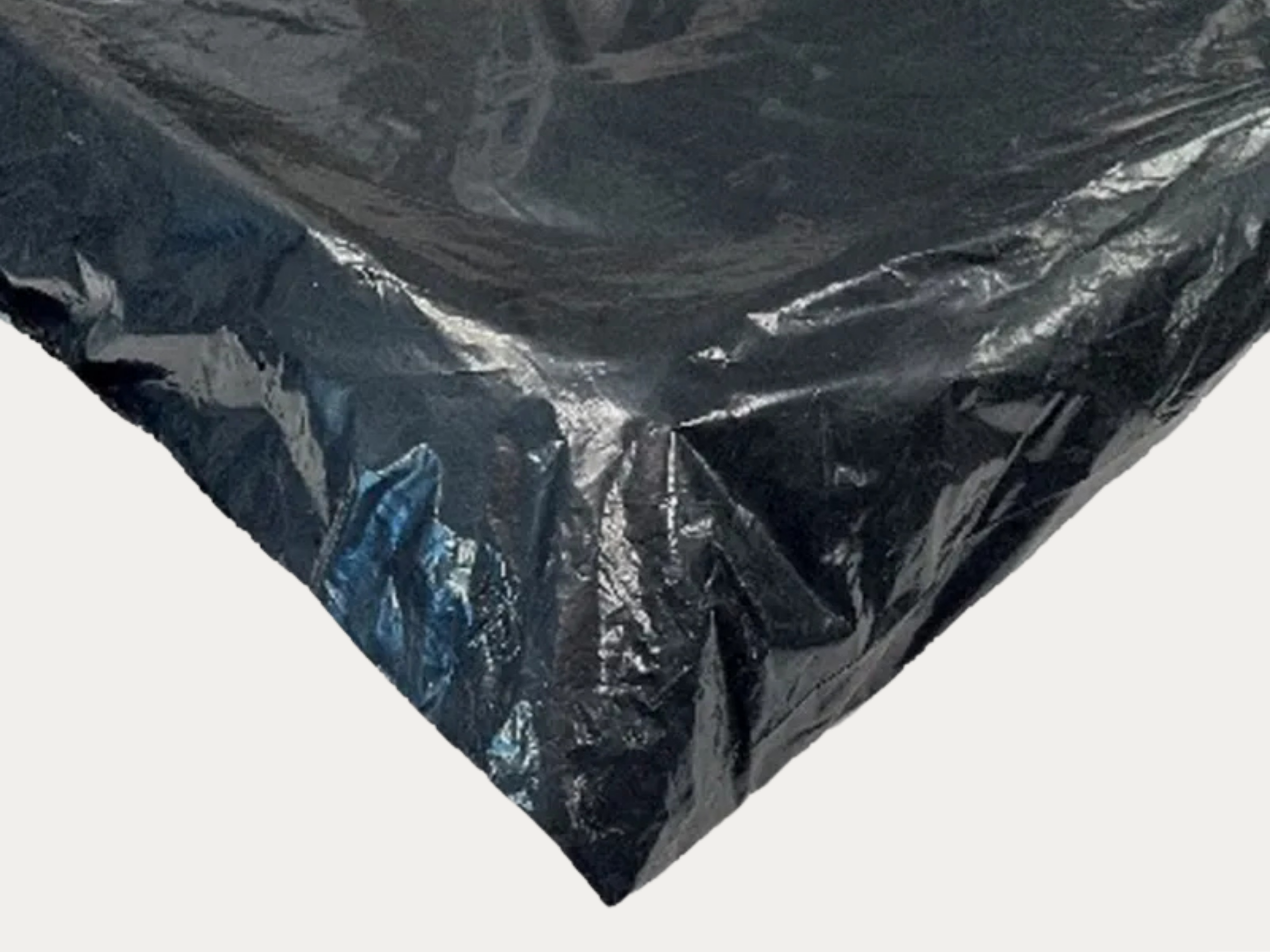 Close-up of a black plastic trash bag with shiny, crinkled surface.