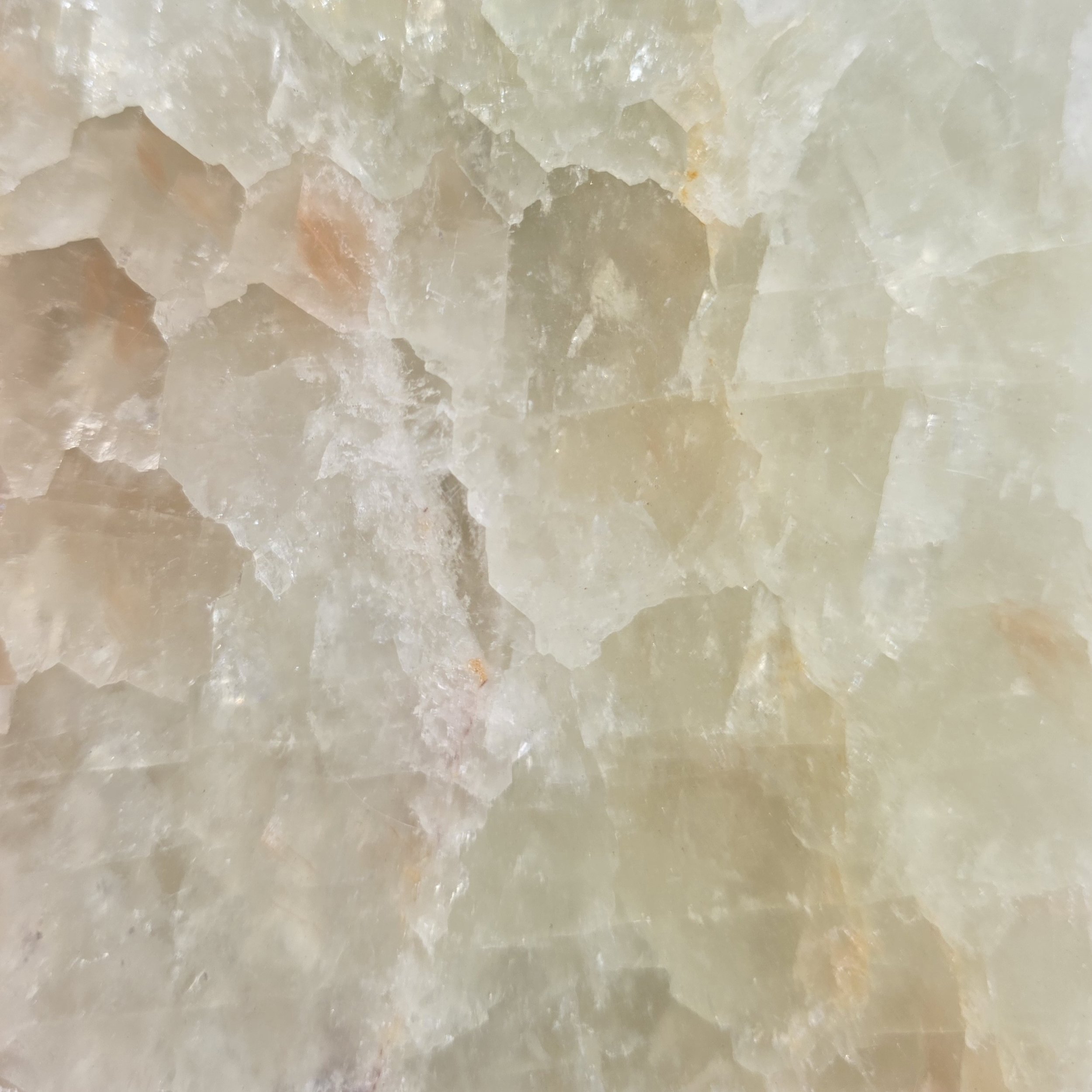 Close-up of an Onyx stone with a mix of cream, beige, and light brown colors.