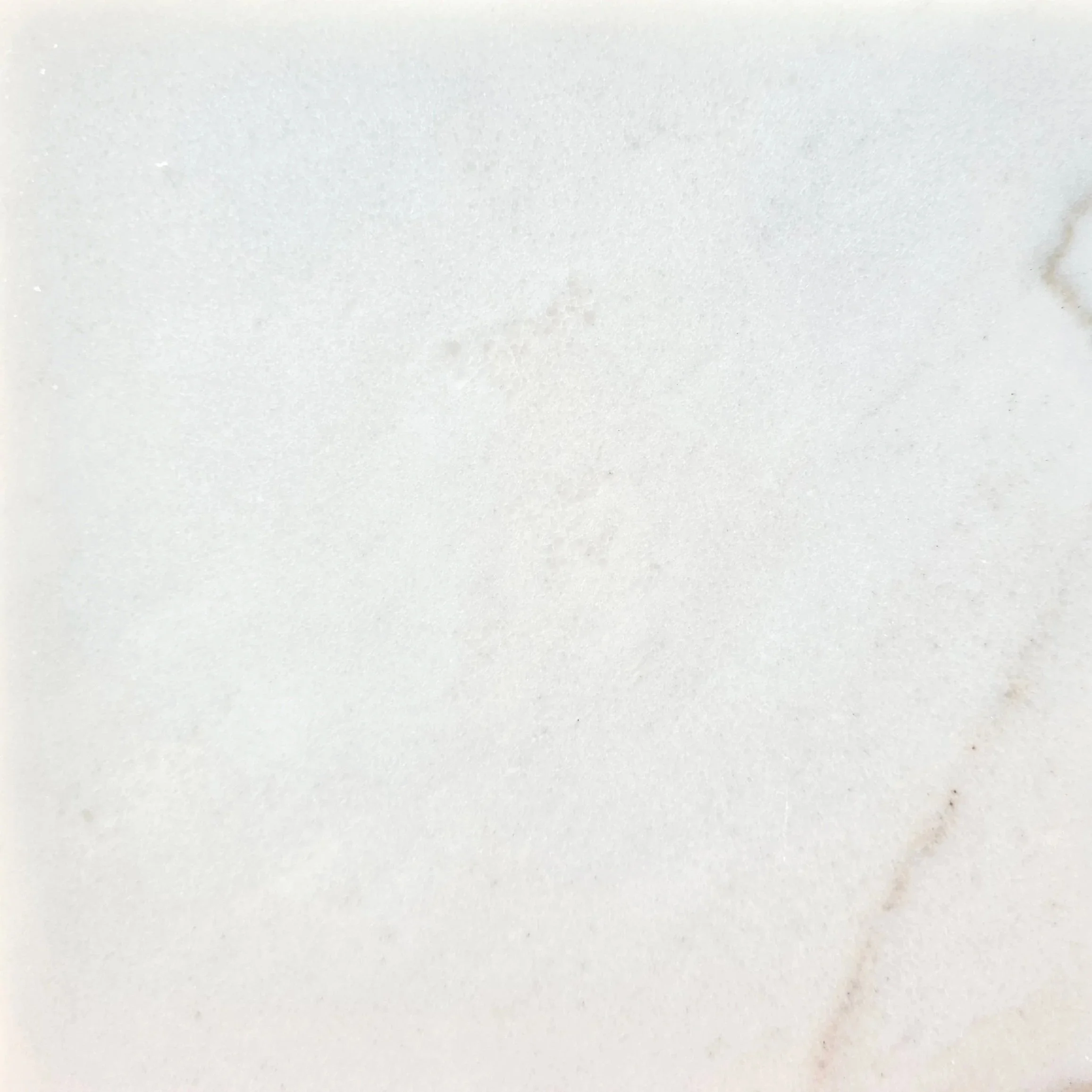 A white marble surface with subtle gray veining.