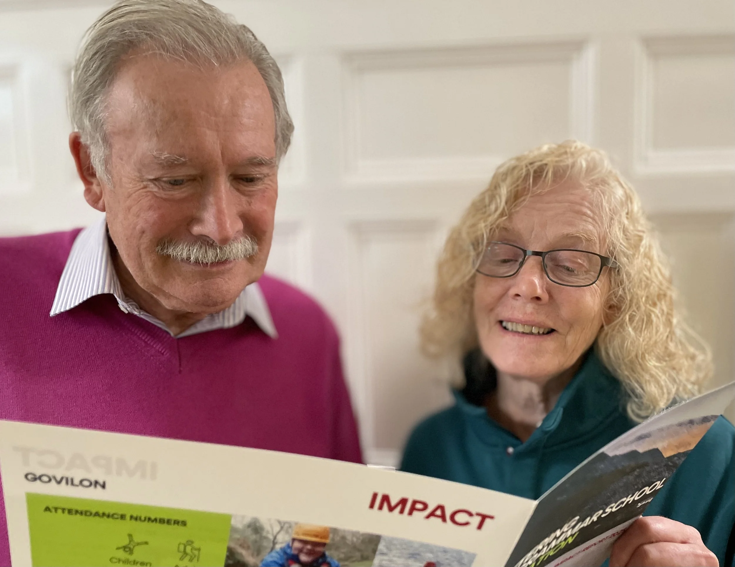 David Watson, Chair of the Foundation’s Trust Board, and Maggie Mitchell, Chair of the Govilon Management Committee, review Kettering Old Grammar School Foundation's 2025 Impact Report.

