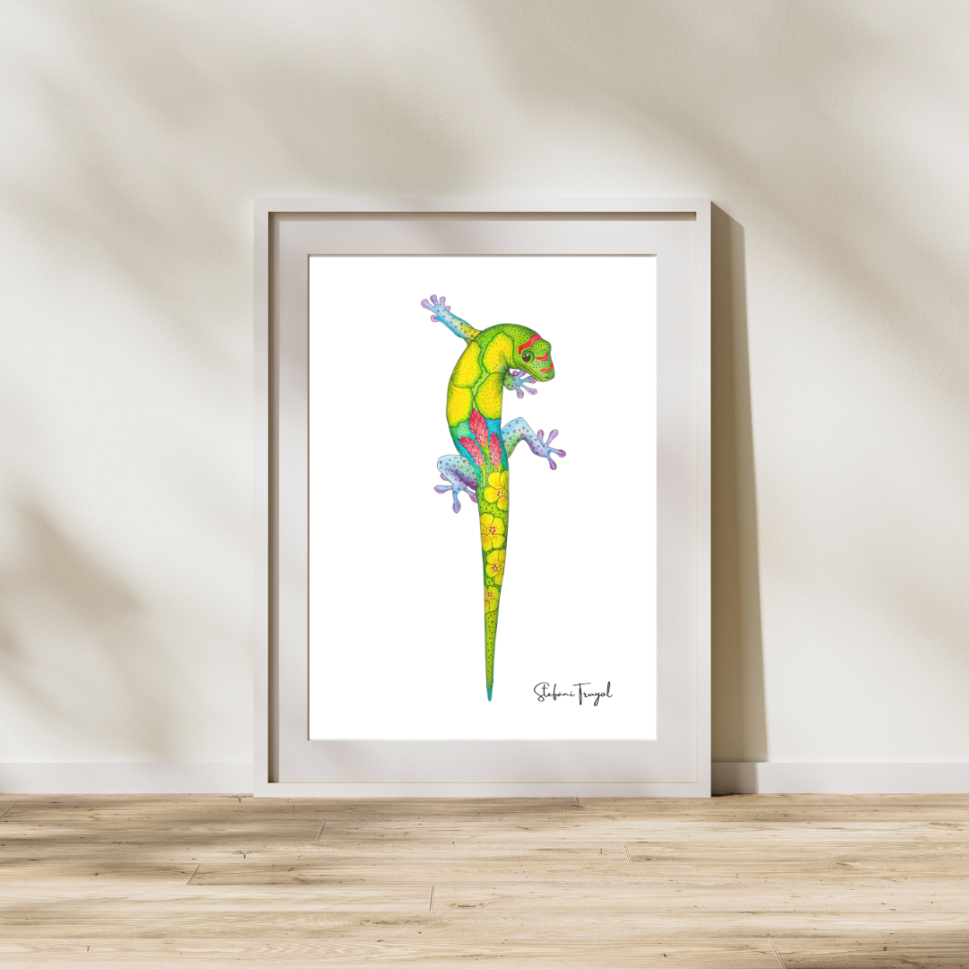 Colorful illustration of a Golden Day Gecko with vibrant patterns and floral designs, framed and leaning against a wall on a wooden floor.