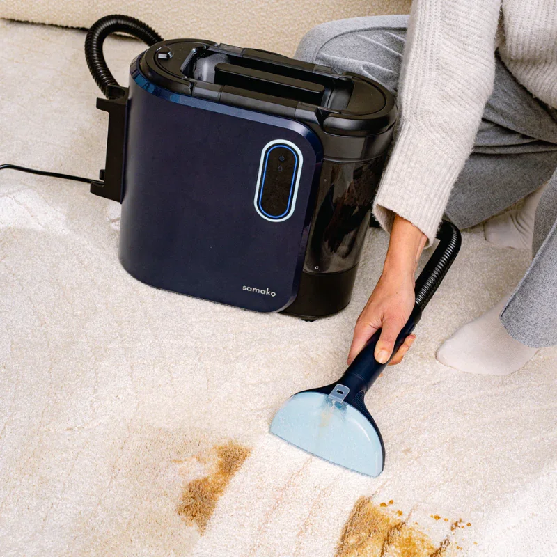 Person die met een stofzuiger de vloer schoonmaakt, een neus in een tapijt, tapijt en een houten vloer zichtbaar.