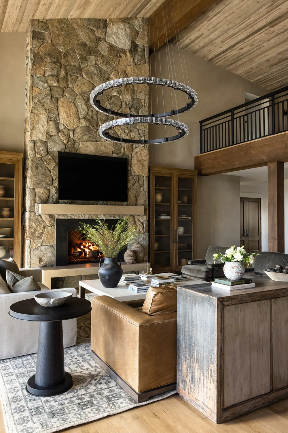 living room with stone fireplace
