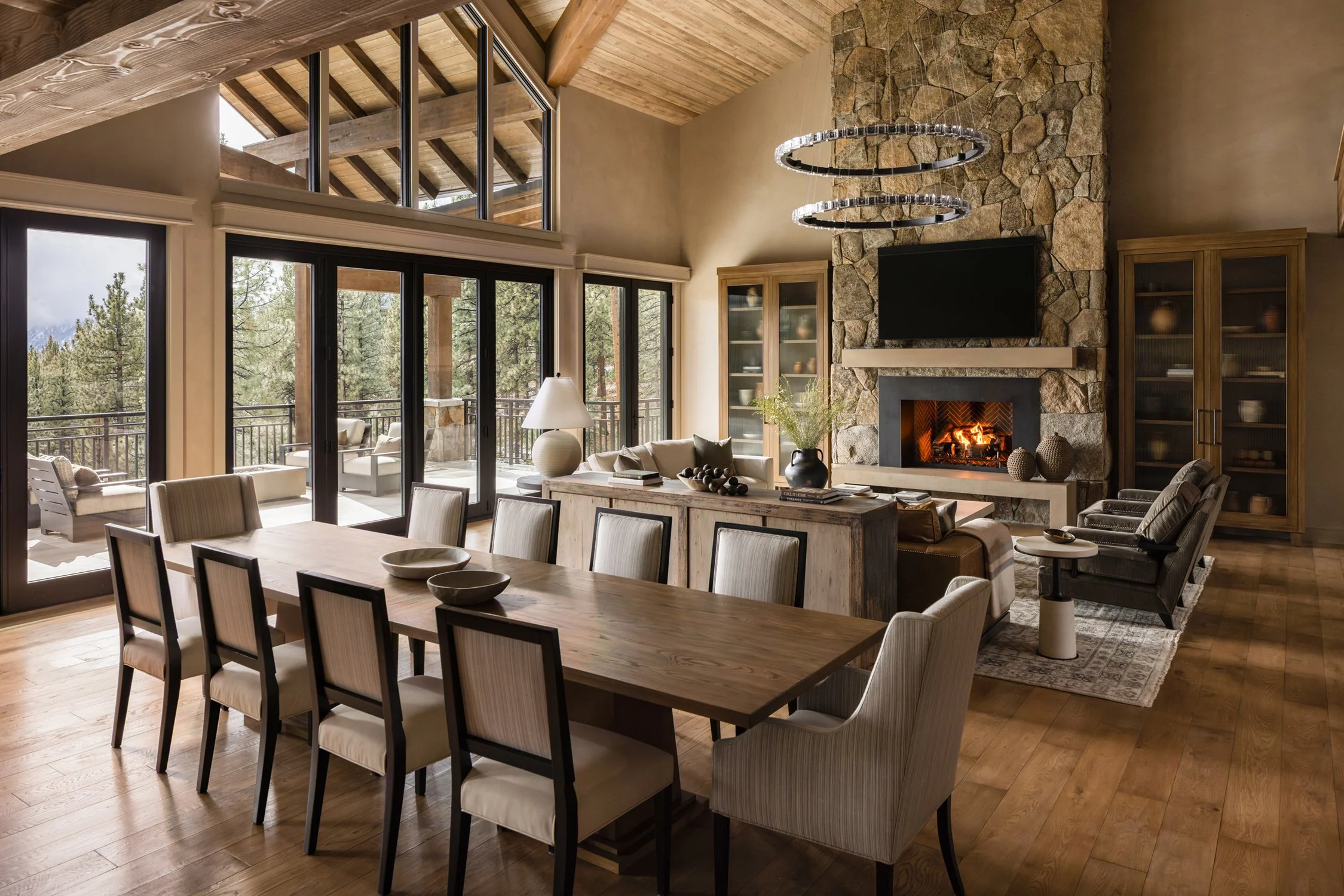 open concept dining room and living room with stone fireplace