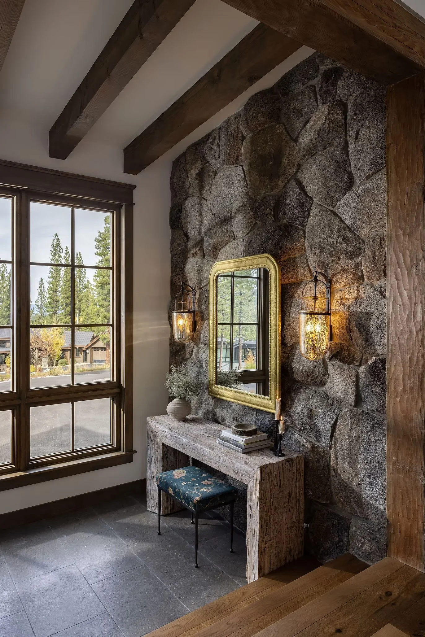 rustic rock wall with seat, table, and mirror