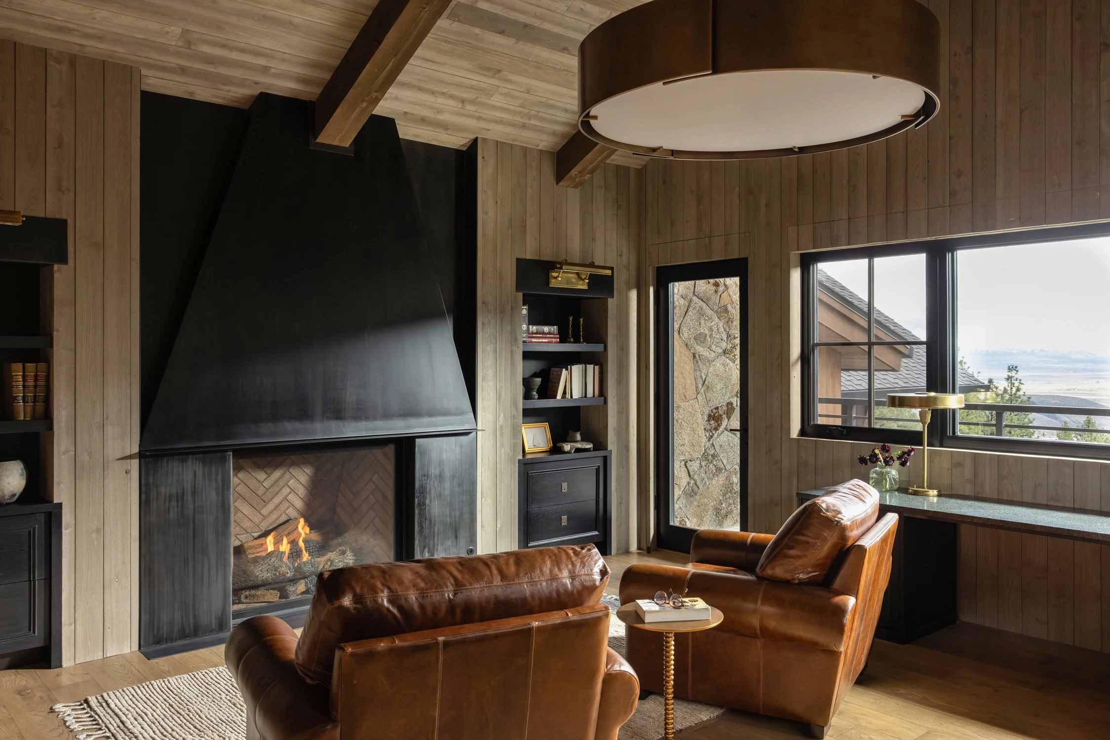 lounge room with brown leather chairs and fireplace