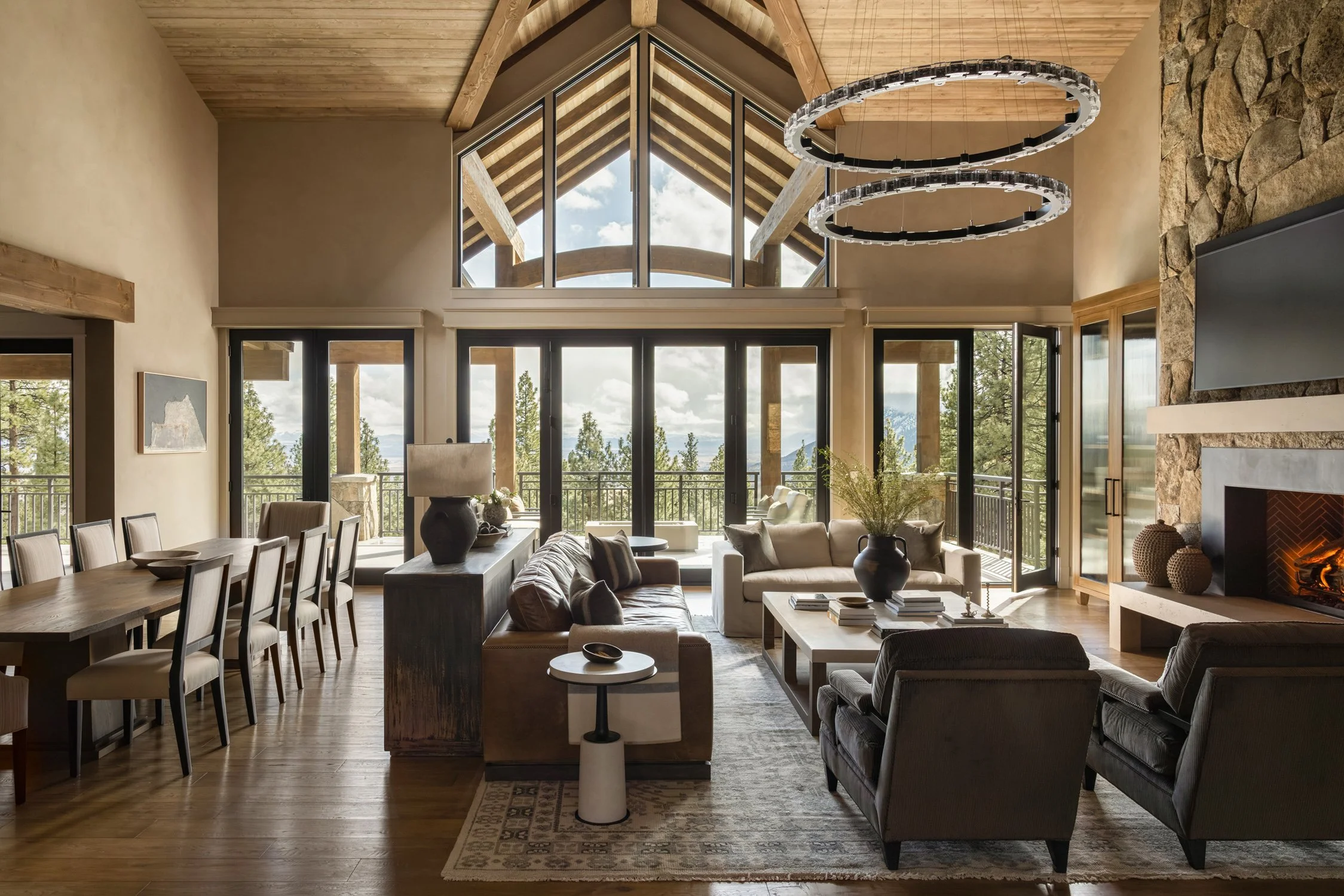open concept dining room and living room with a fireplace and large balcony