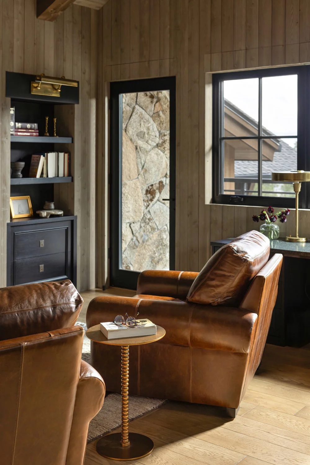 lounge room with brown leather chairs